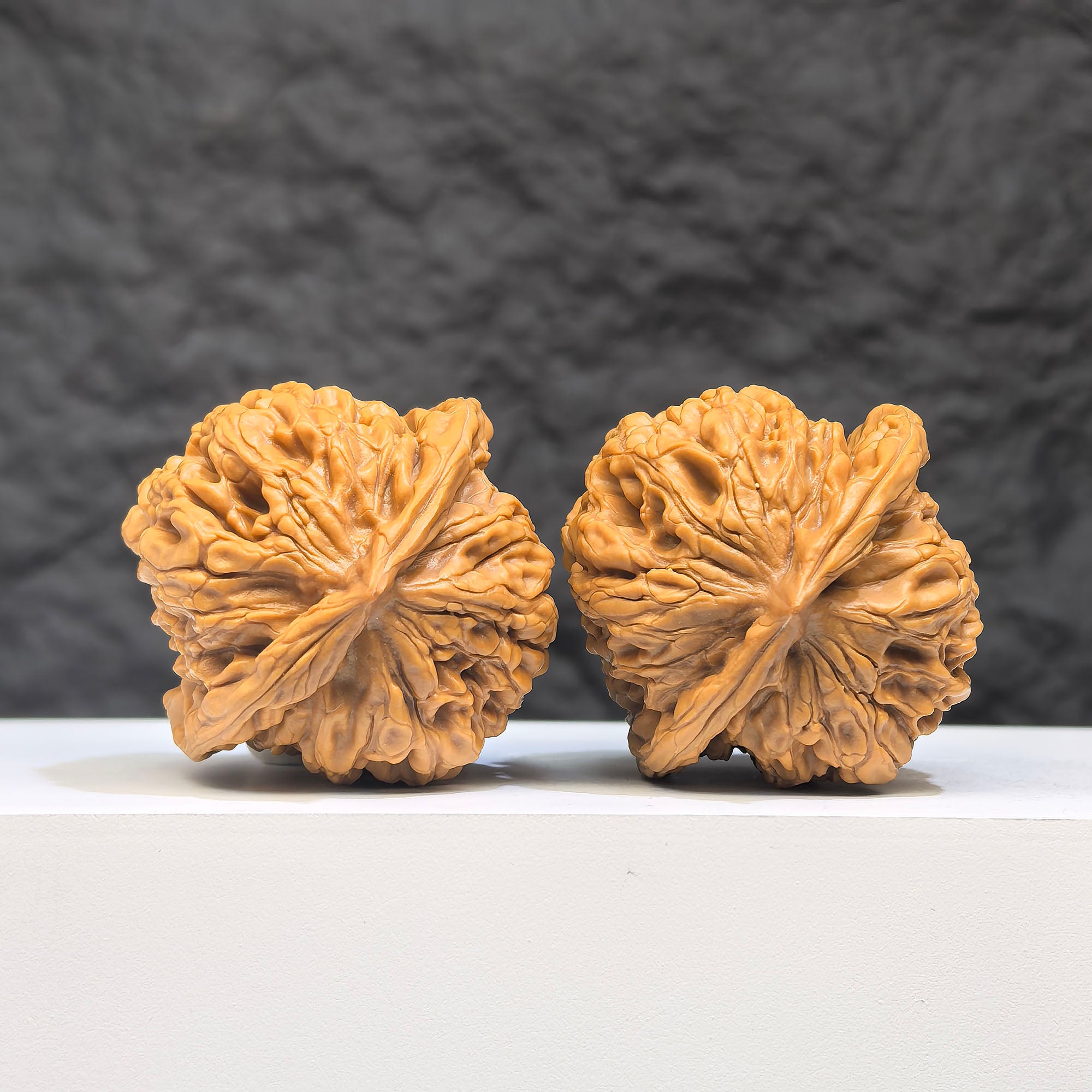 Wenwan Art Hundred Beasts Lion Head Wenwan Walnut pair, 38mm x 36mm, featuring intricate lion head carvings on walnut surfaces.