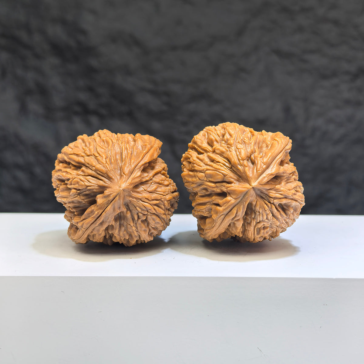 Pair of Nanjiangstone Wenwan walnuts from Wenwan Art, 38mm diameter, showcasing smooth, polished walnut-shaped stones.