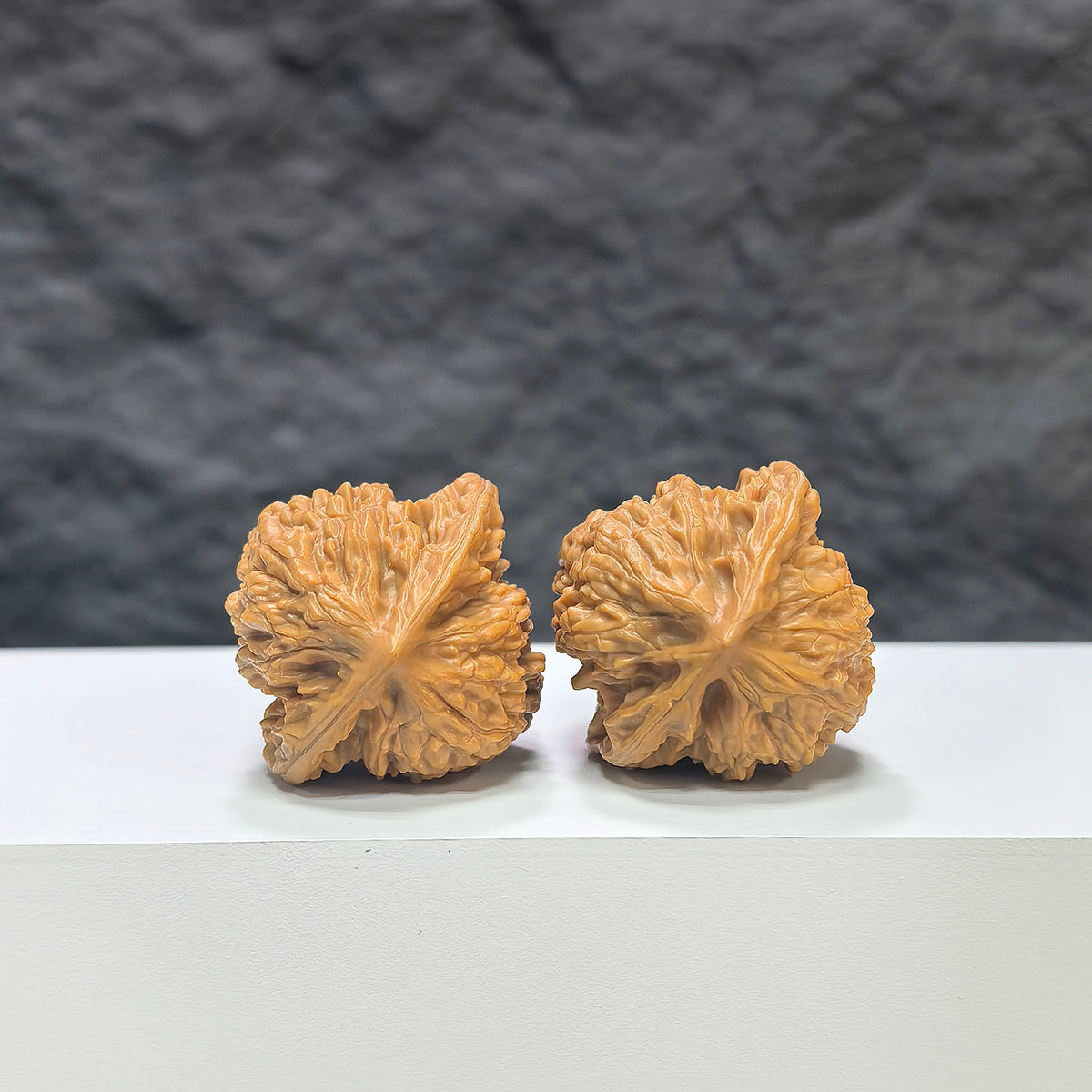 Pair of miniature Wenwan walnuts from Wenwan Art, 32mm size, featuring detailed natural walnut carvings and smooth polished surfaces.