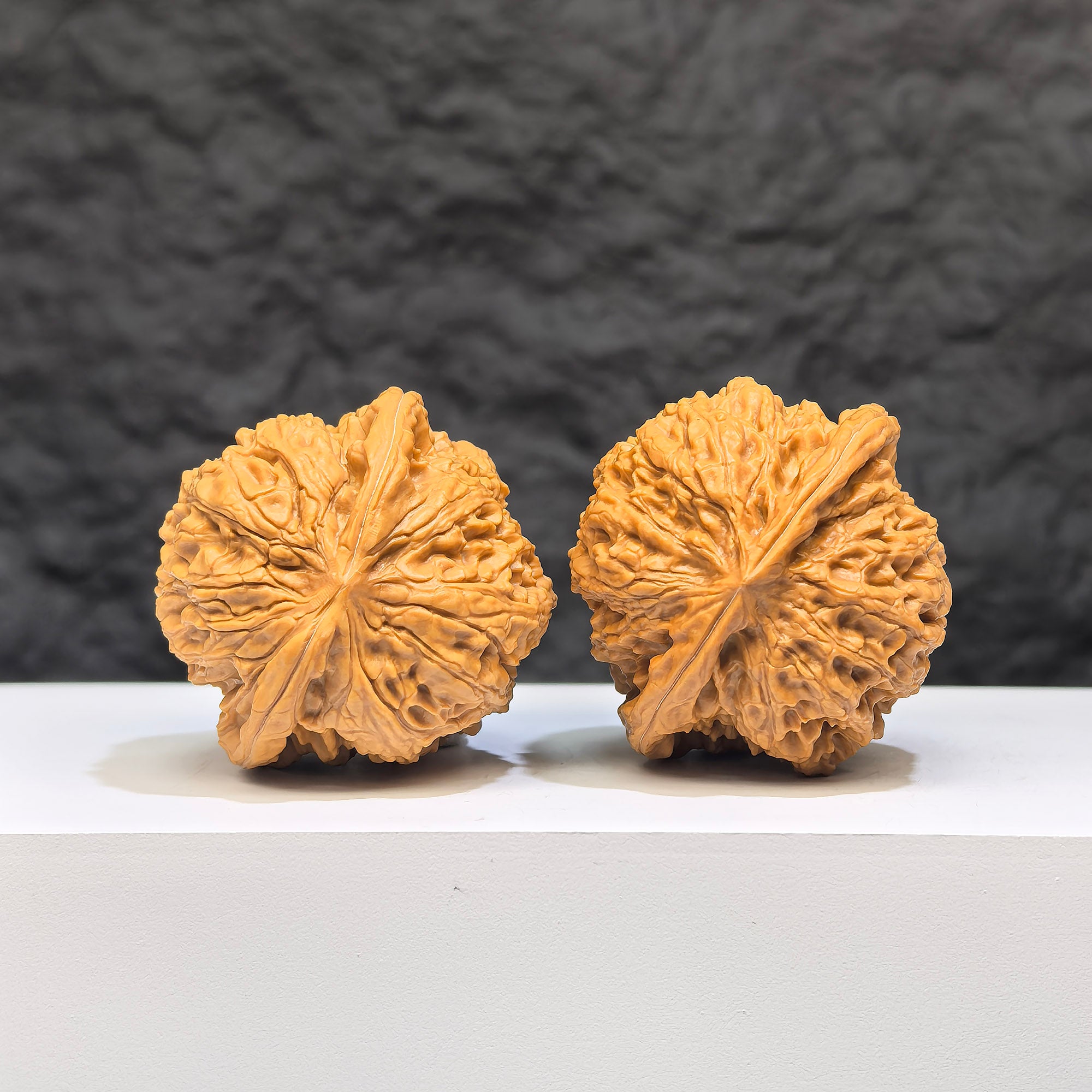 Yuhua Stone Wenwan Walnut pair from Wenwan Art, 37mm x 34mm, featuring smooth, polished classic walnut carvings with intricate patterns.