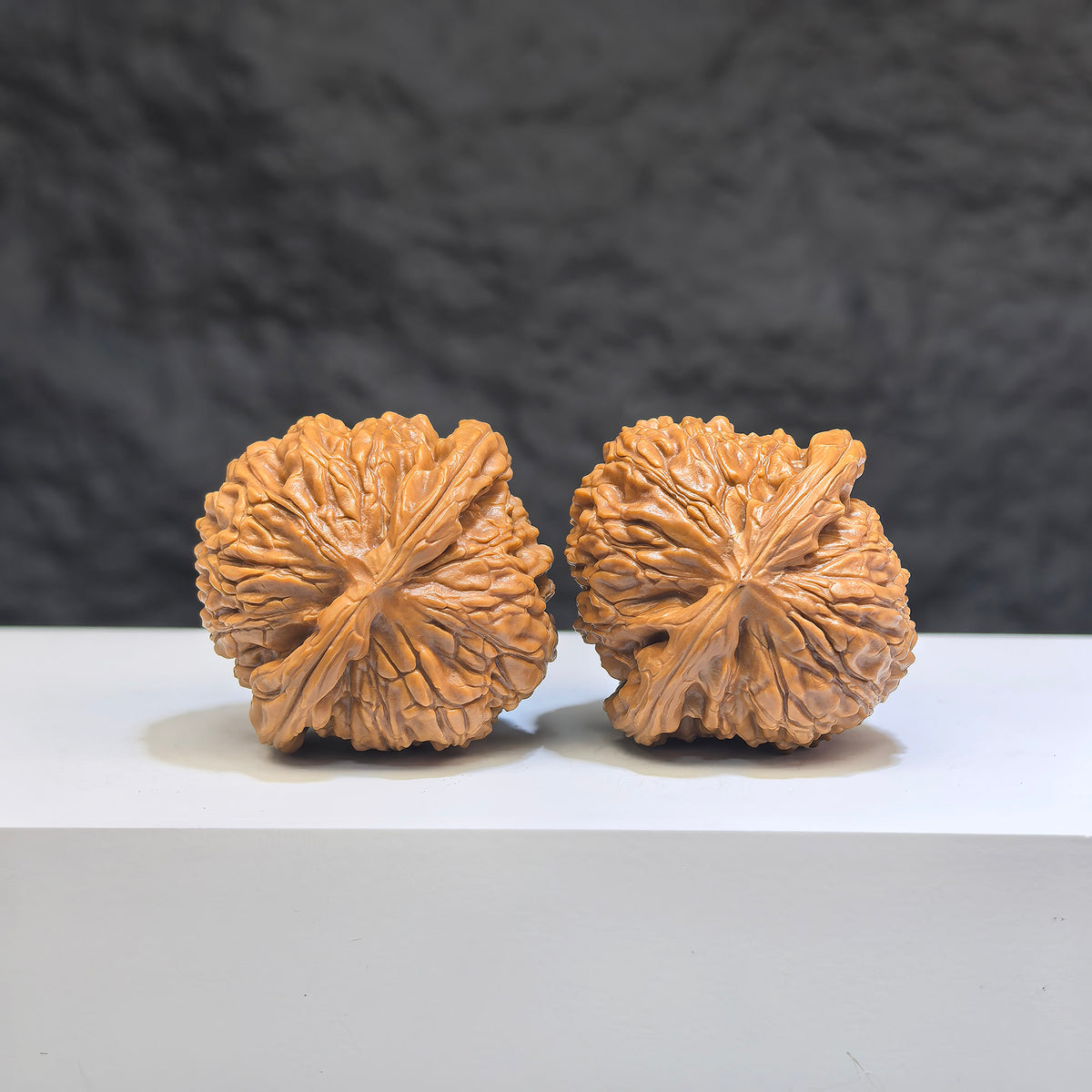 Pair of white spherical Wenwan walnuts featuring lion carvings, 35mm size, from Wenwan Art with round-profile design.