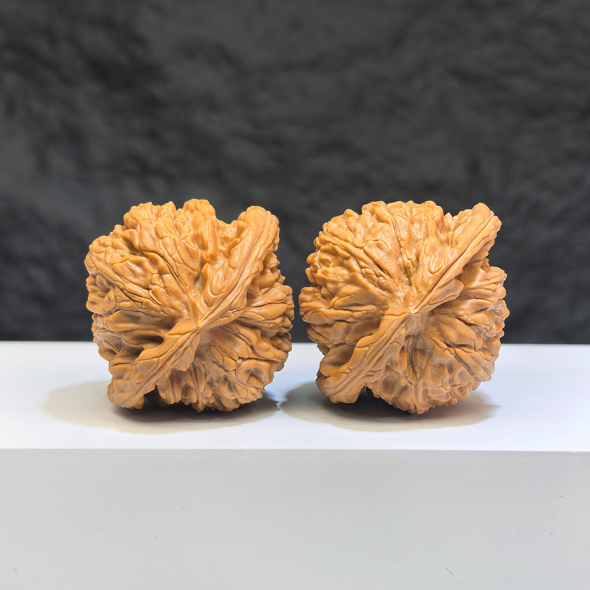 Pair of White Lion Wenwan Walnuts from Wenwan Art, 41mm x 38mm, featuring intricate carvings and smooth polished surface.