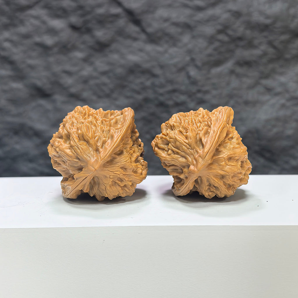 Pair of Wenwan Art Arhat Head round-profile Wenwan walnuts, 41mm x 38mm, showcasing detailed carved walnut heads.