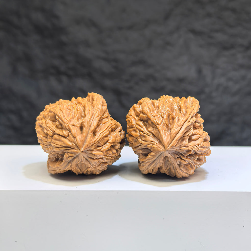 Pair of Nanjiangstone Wenwan walnuts by Wenwan Art, 36mm, showing detailed natural stone texture and polished surface.