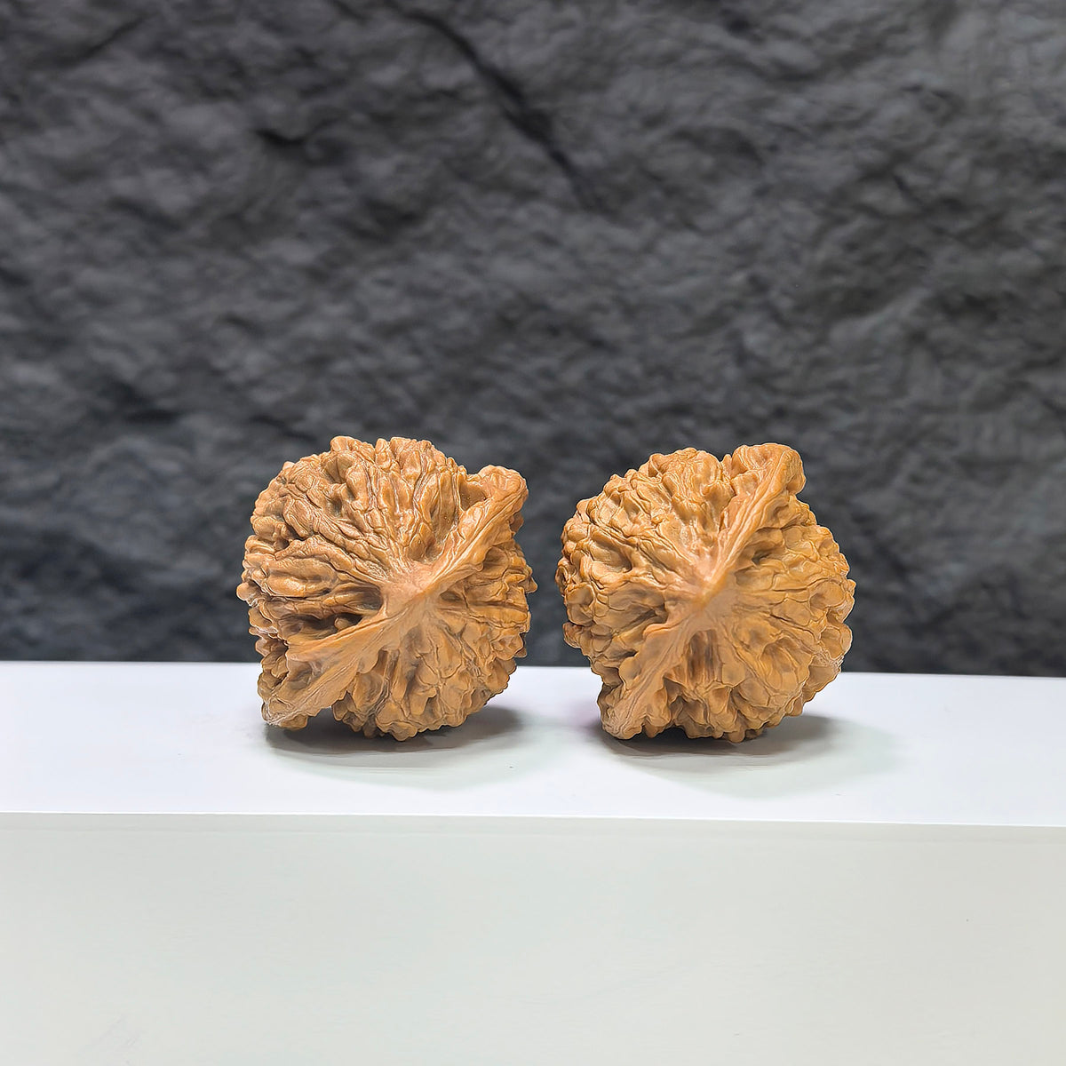 Pair of Kylin Texture Wenwan Walnuts by Wenwan Art, featuring 麒麟紋 pattern, 39mm x 35mm, with detailed textured surface.