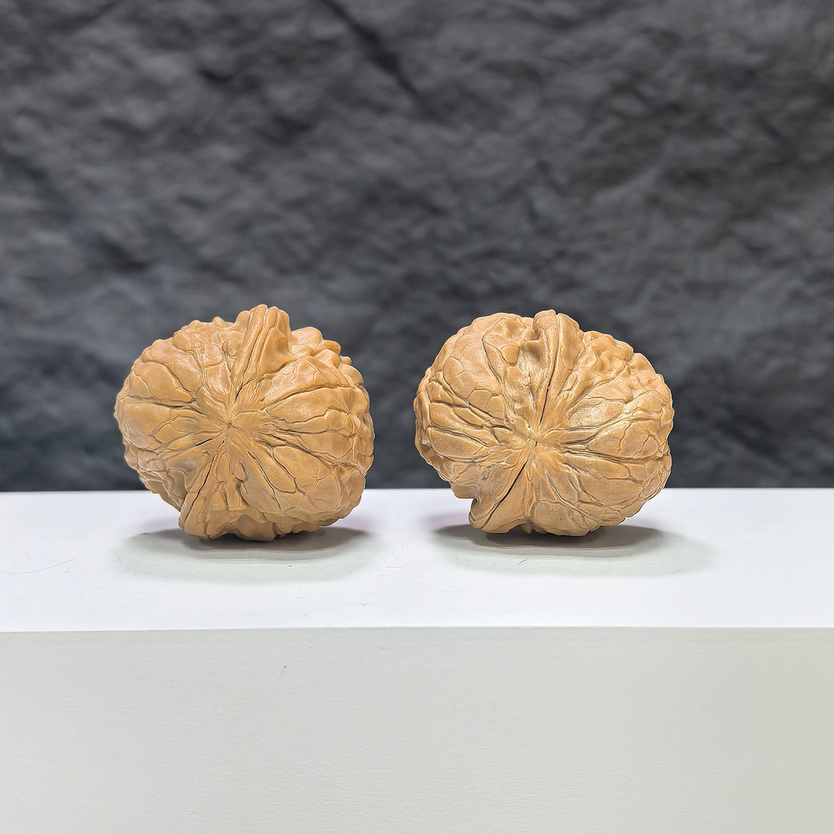 Miniature Wenwan Walnut pair featuring golden toad vessel design, crafted by Wenwan Art, measuring 34x37mm.