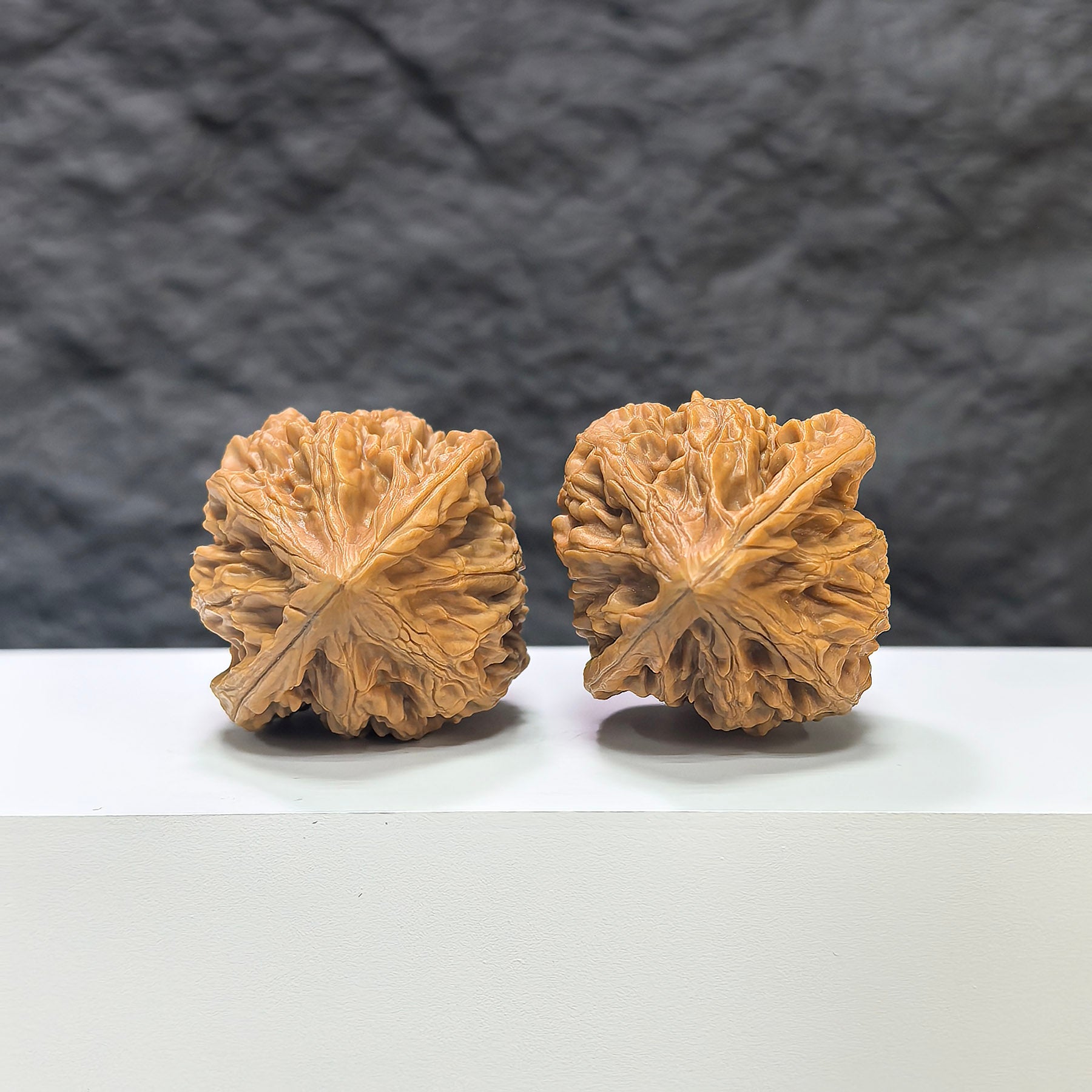 Pair of Beijing Chicken Heart Wenwan walnuts from Wenwan Art, 41mm x 40mm, showcasing smooth, rounded walnut shapes with natural wood patterns.
