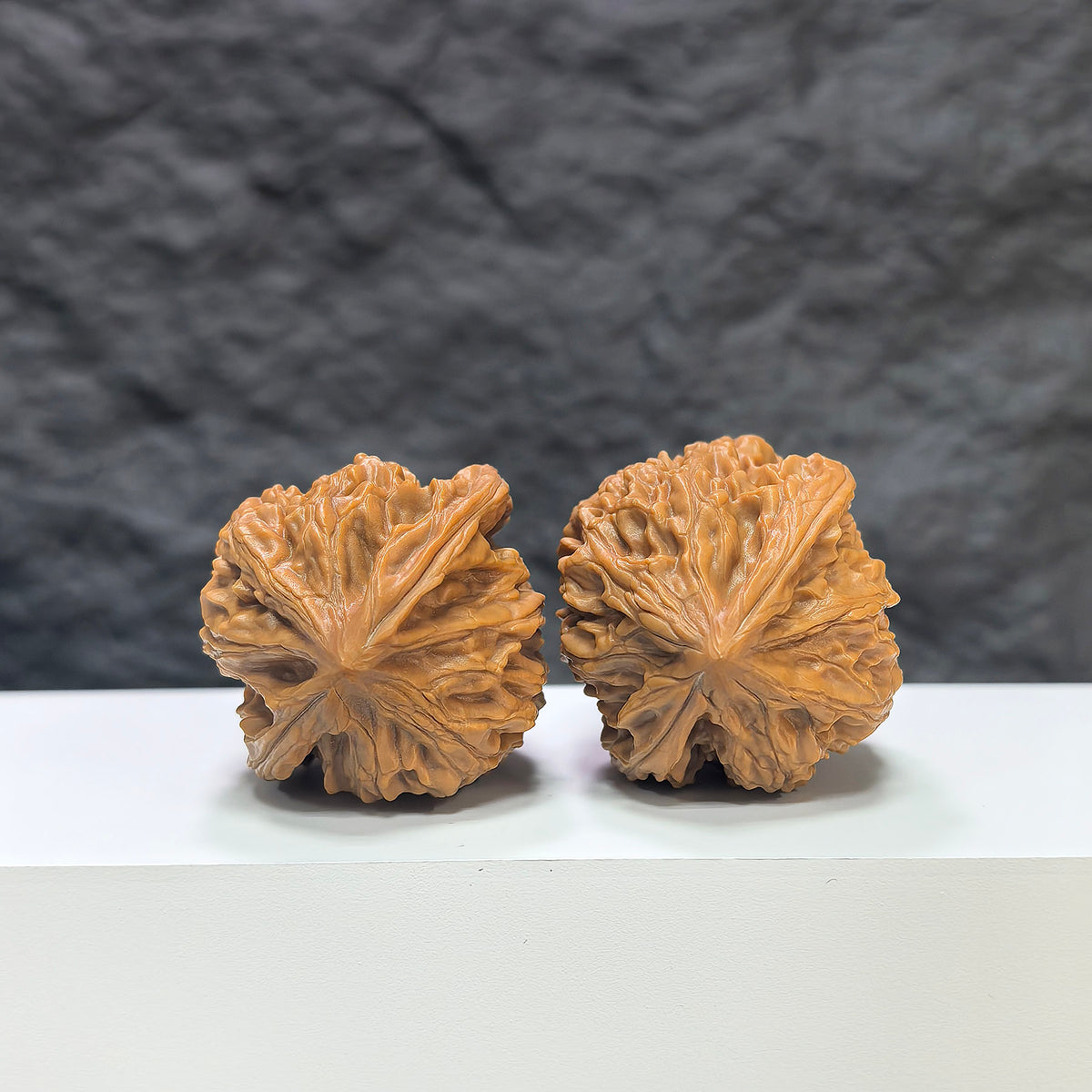 Pair of Beijing Chicken Heart Wenwan walnuts by Wenwan Art, 41mm x 40mm, featuring smooth, polished classic walnut surfaces.
