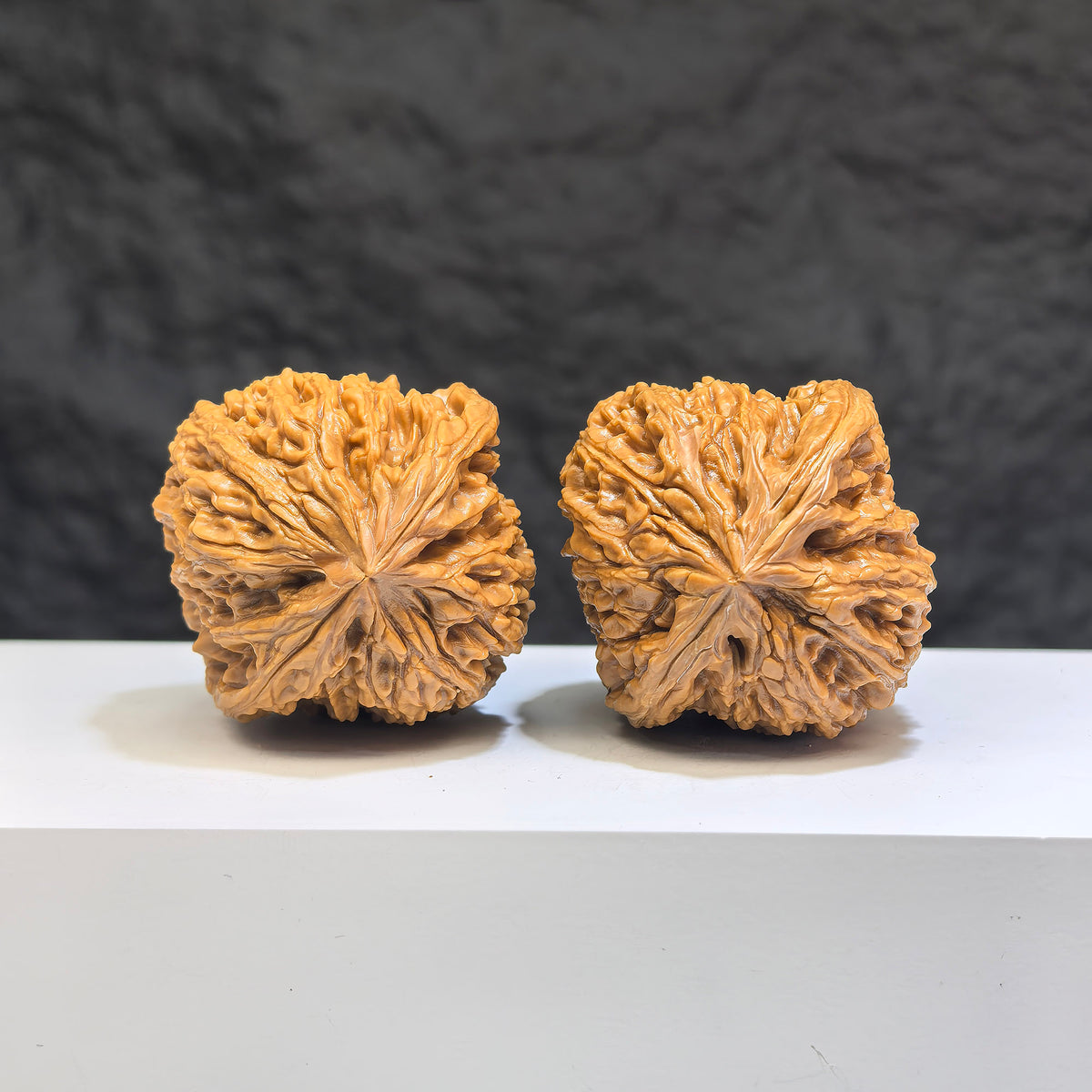 Pair of Nanjiangstone Wenwan walnuts from Wenwan Art, 41mm x 40mm, featuring natural stone textures and smooth polished surfaces.