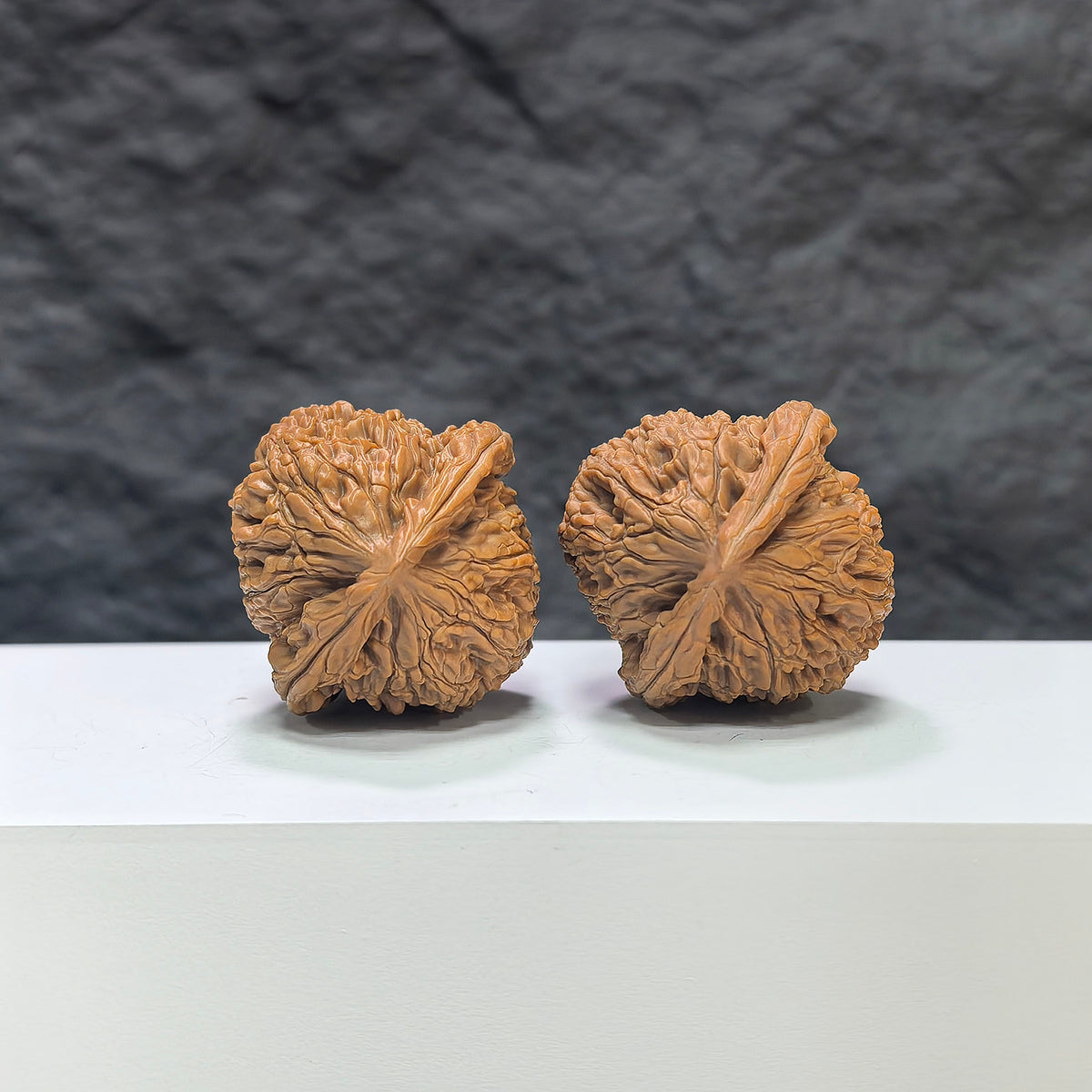 Pair of Water Dragon Texture Wenwan Walnuts by Wenwan Art, 37mm x 36mm with intricate water dragon pattern.