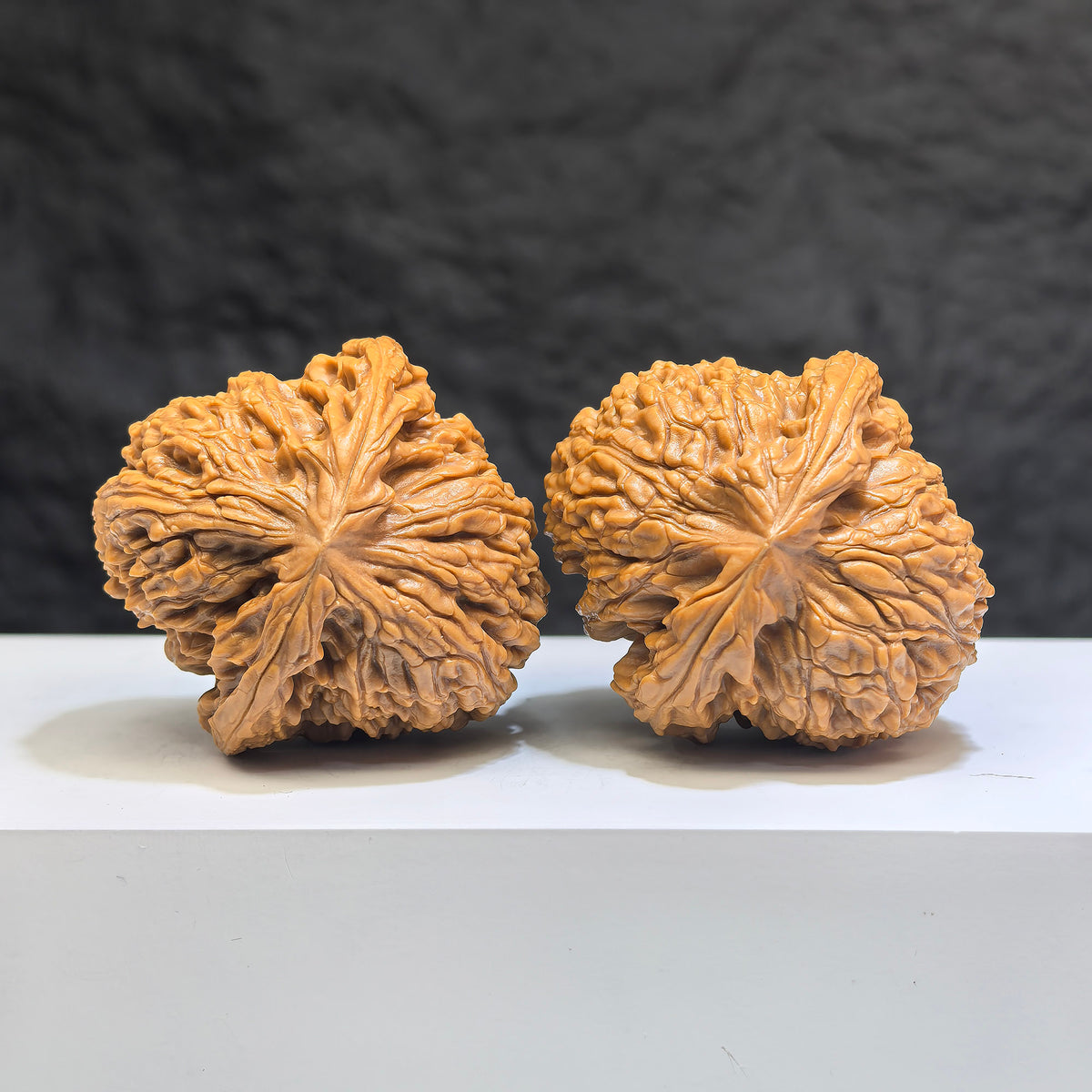 Pair of spherical Wenwan Walnuts made from Nanjiangstone, 41-43mm, showcasing smooth round profiles and natural stone textures.