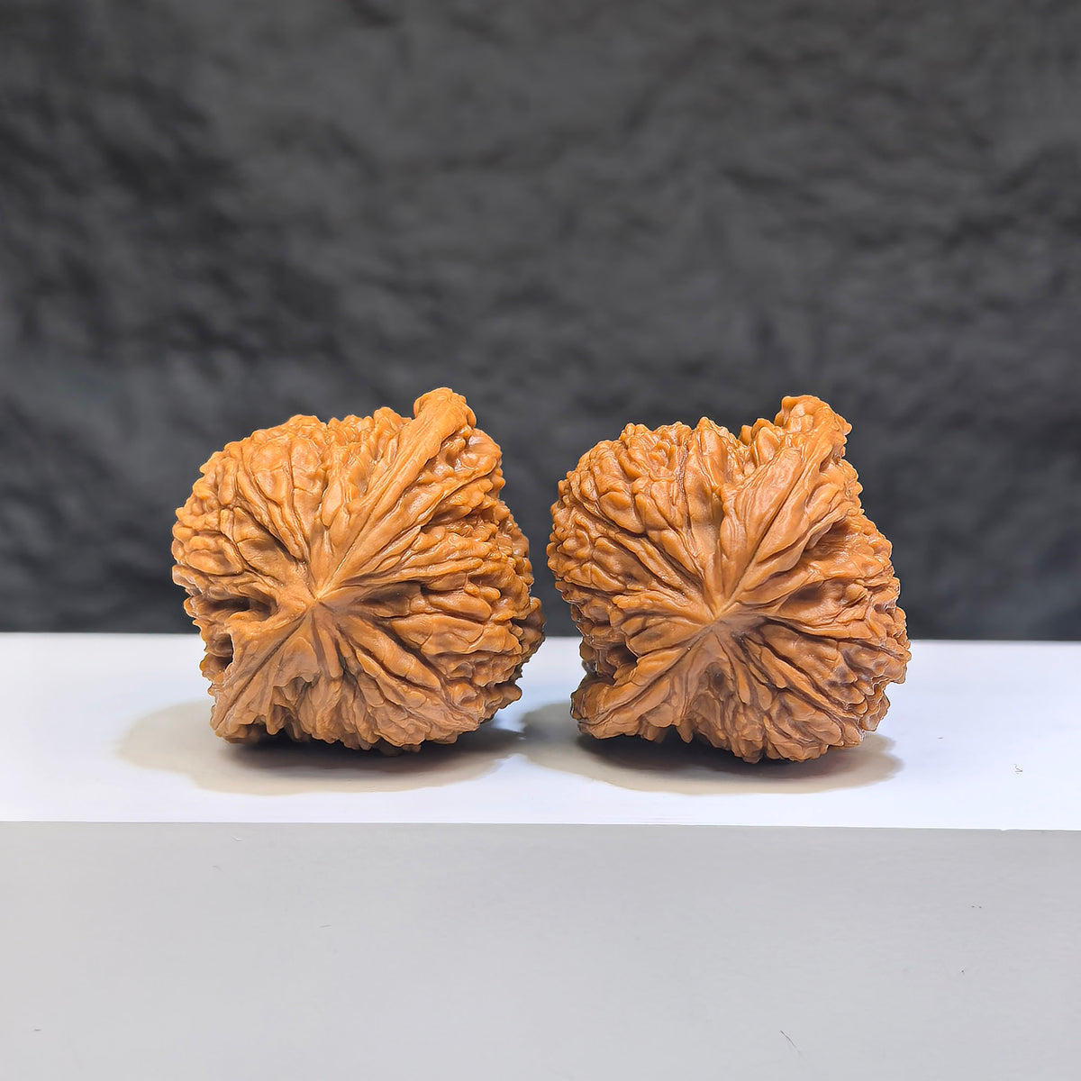 Pair of Red Shell Nanjiangstone Wenwan walnuts from Wenwan Art, 40mm x 38mm, showcasing smooth, polished classic walnut shapes.