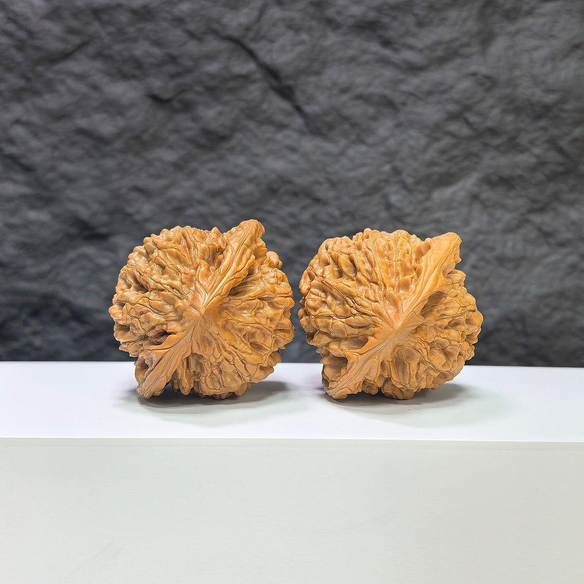 Pair of large Wenwan Art official hat-shaped walnuts, 47mm x 42mm, featuring smooth, polished walnut surfaces on a neutral background.