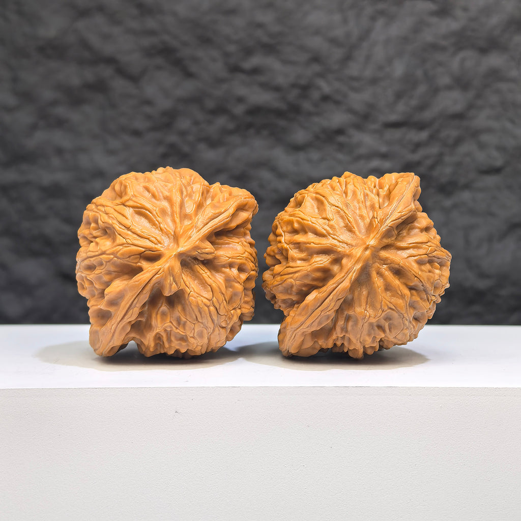 Pair of Palace Lantern Wenwan walnuts from Wenwan Art, 44mm x 38mm, featuring intricate carvings and traditional designs.