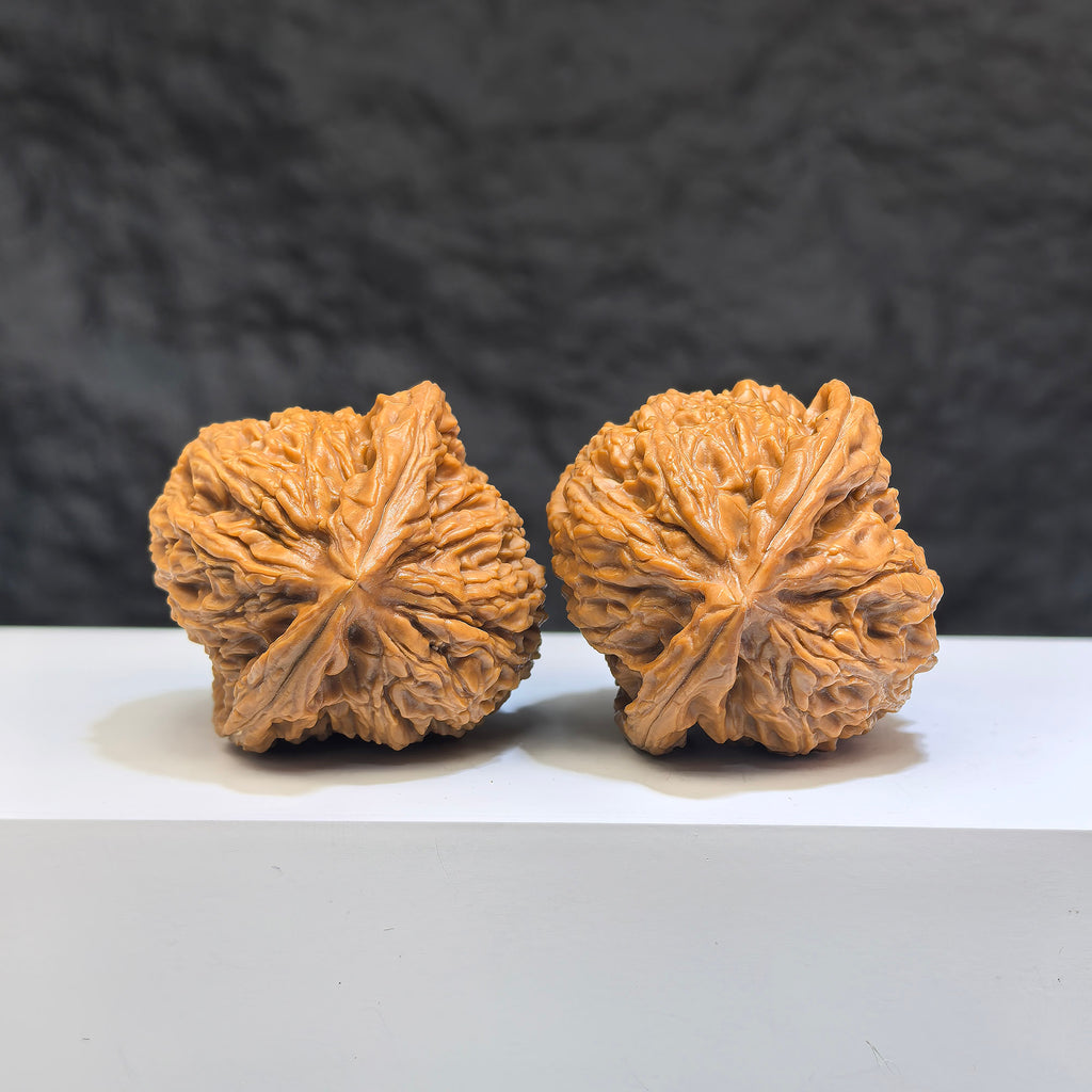 Pair of Nanjiangstone Wenwan walnuts from Wenwan Art, 38mm x 39mm, showcasing natural stone texture and craftsmanship.