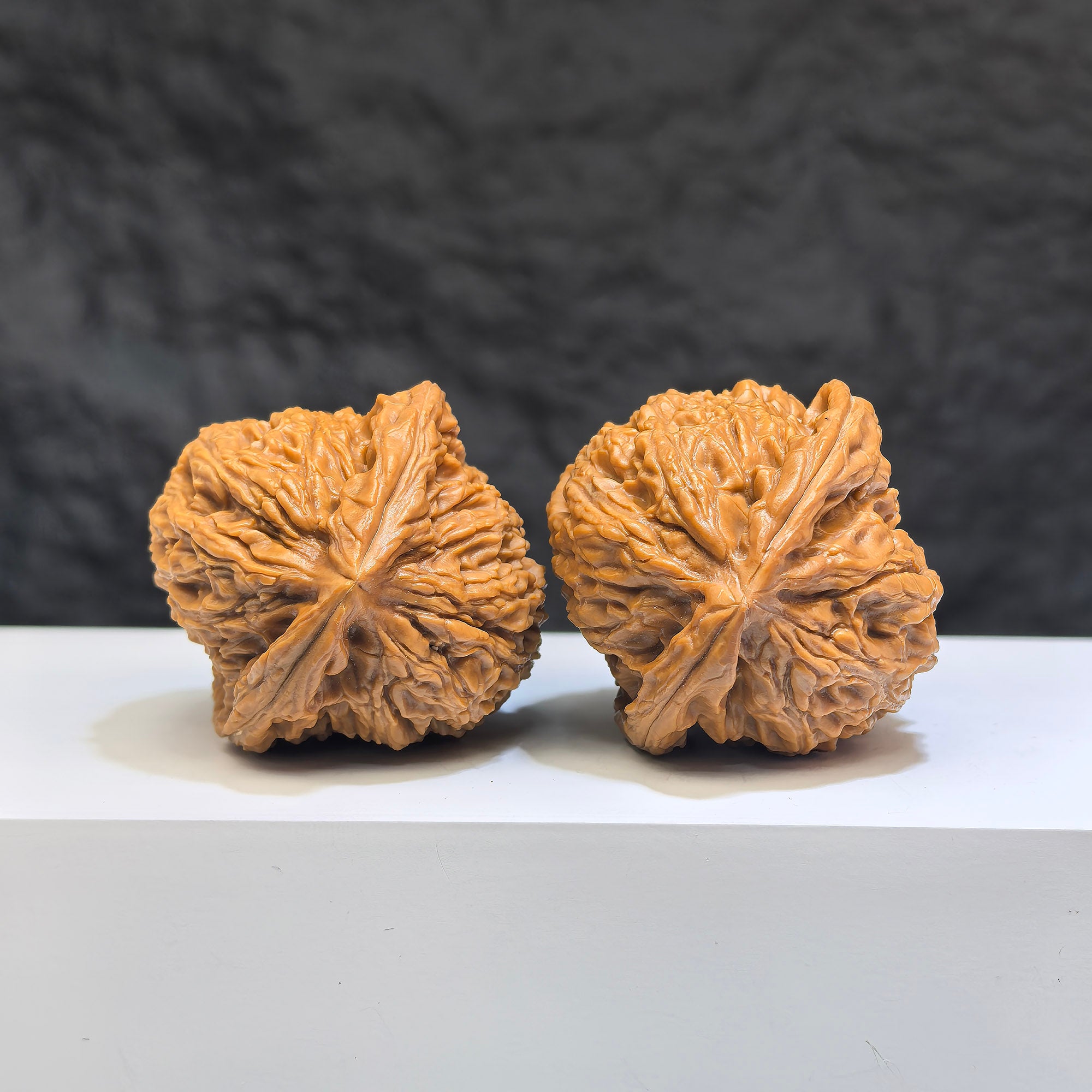 Pair of Nanjiangstone Wenwan walnuts from Wenwan Art, 38mm x 39mm, showcasing natural stone texture and craftsmanship.