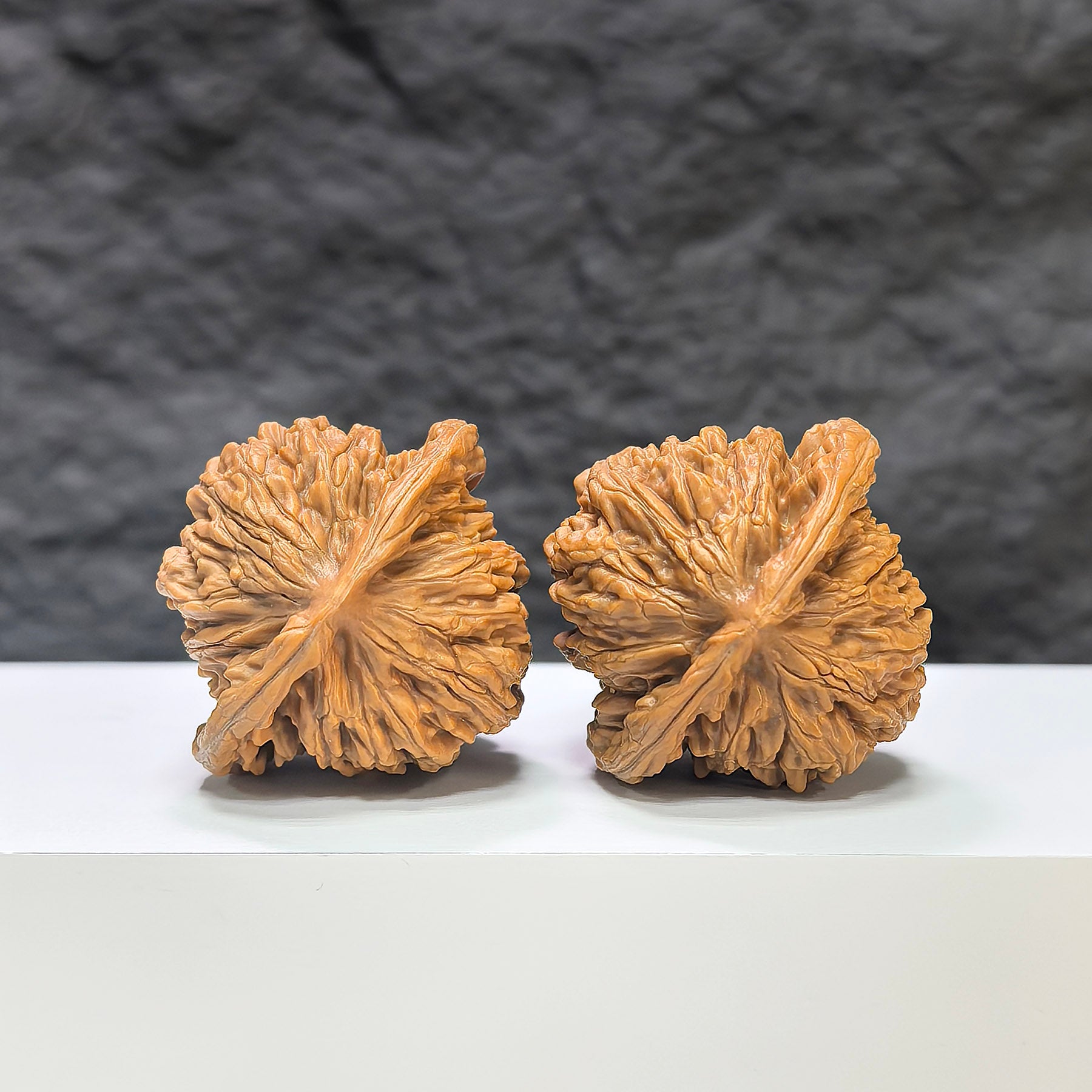 Pair of Sizuolou Wenwan walnuts by Wenwan Art, 39mm x 37mm, showcasing detailed carved patterns on smooth, polished wood.