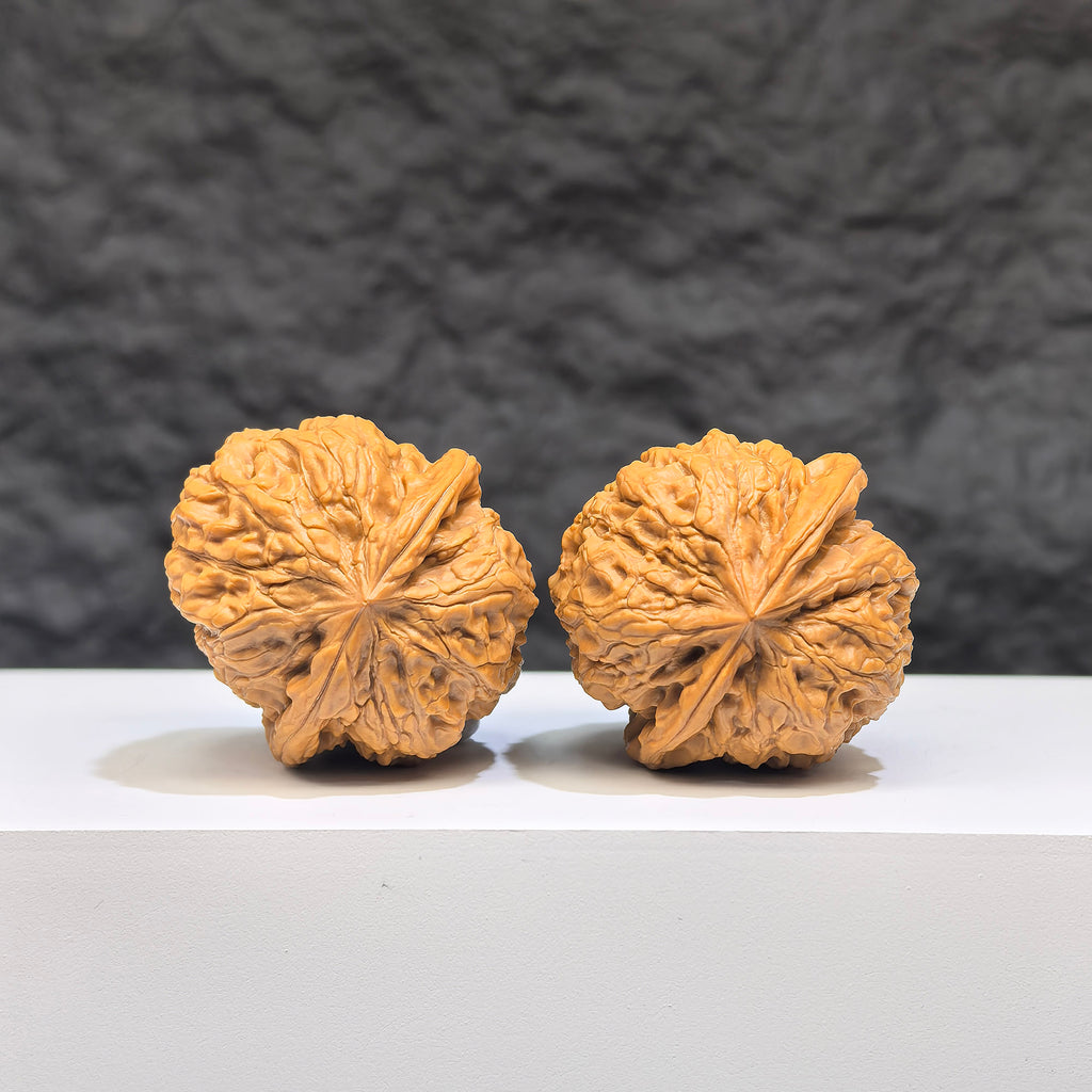 Miniature Wenwan Walnut pair from Wenwan Art, Yuhua Stone, 32mm, showcasing detailed natural stone textures and polished surface.