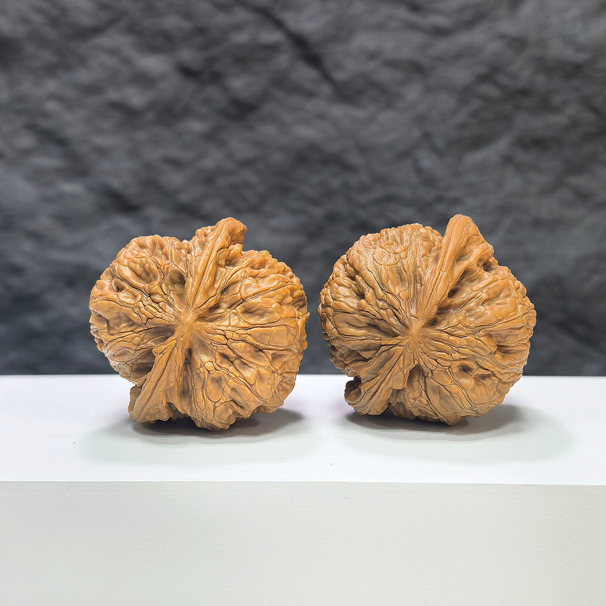 Pair of North China General Shoulder Wenwan walnuts by Wenwan Art, 40mm, showcasing detailed natural walnut textures and smooth surfaces.