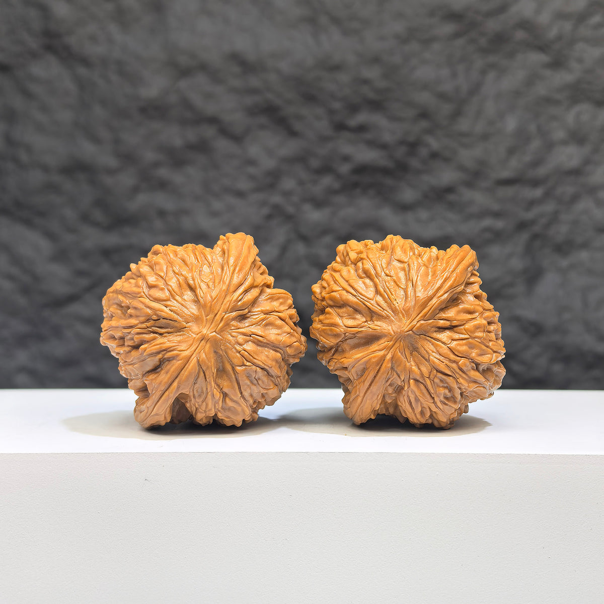 Red shell Wenwan walnut pair with polished millstone design, measuring 42mm x 38mm, from Wenwan Art.