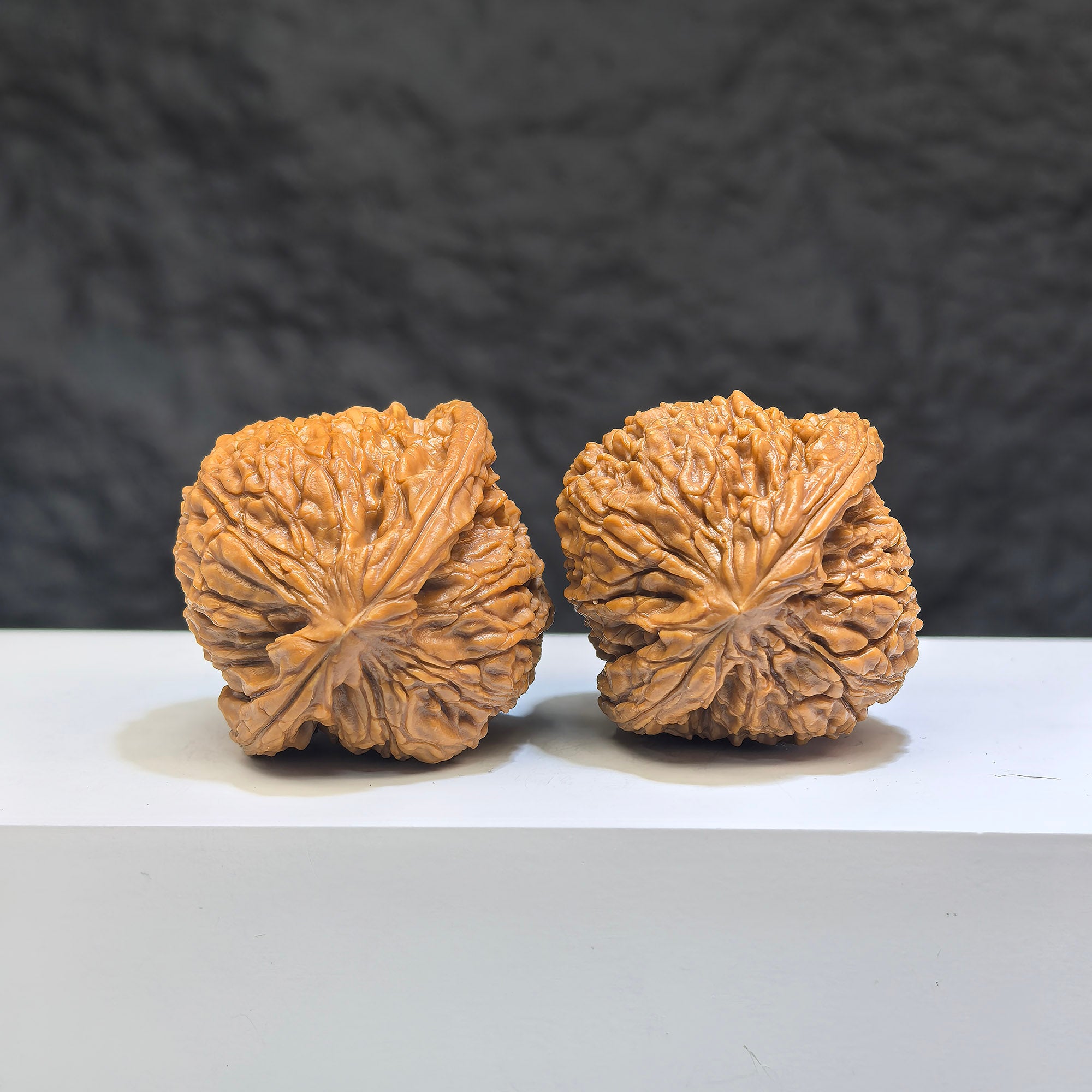 Pair of Nanjiangstone Wenwan walnuts from Wenwan Art, 37mm x 37mm, showcasing polished, natural stone craftsmanship.