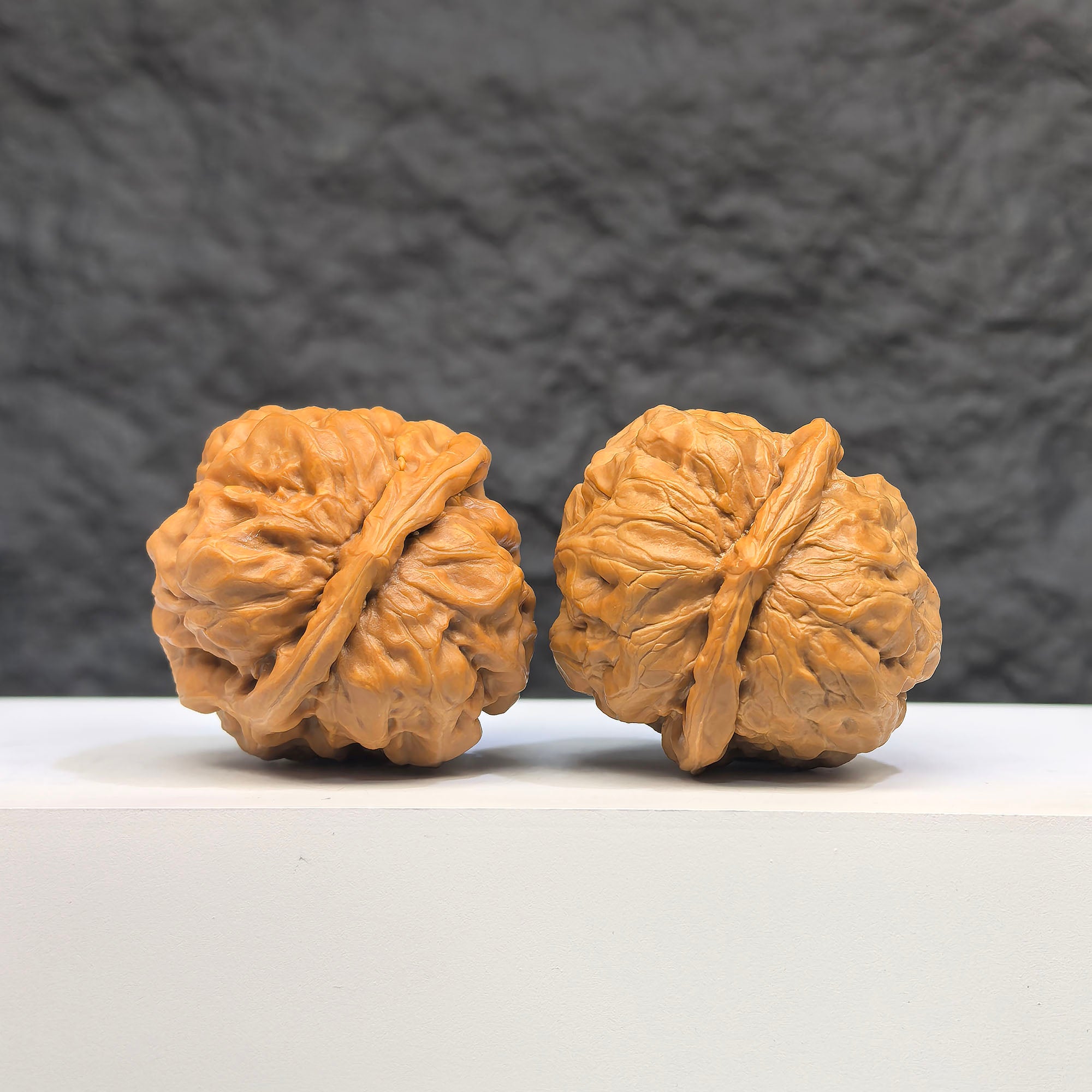 Pair of Toad Head Wenwan walnuts from Wenwan Art, featuring detailed carvings and natural brown tones, measuring 37mm by 35mm.