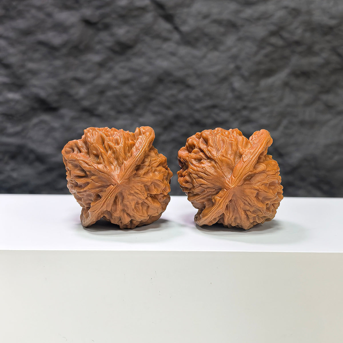 Pair of porcelain doll-shaped Wenwan walnuts from Wenwan Art, smooth glaze finish, 38mm size, detailed and decorative.