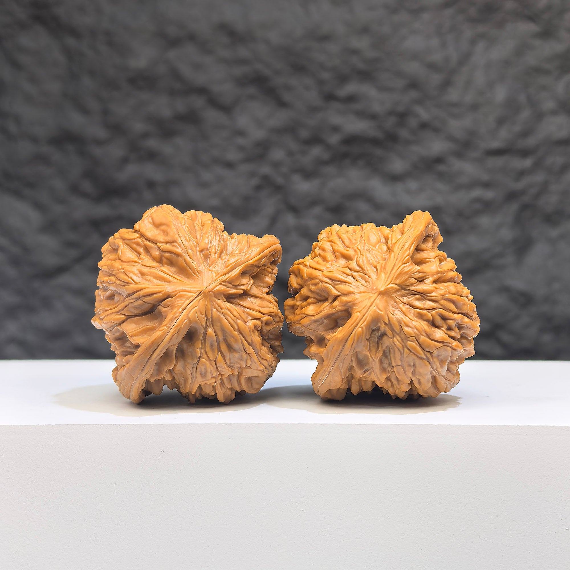 Pair of Butterfly Millstone Wenwan walnuts by Wenwan Art, 38mm x 37mm, featuring detailed butterfly and millstone carvings.