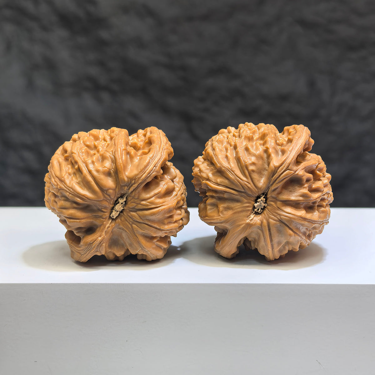 Pair of spherical white lion Wenwan walnuts from Wenwan Art, round profile, approximately 44mm x 43mm, featuring detailed lion carvings.