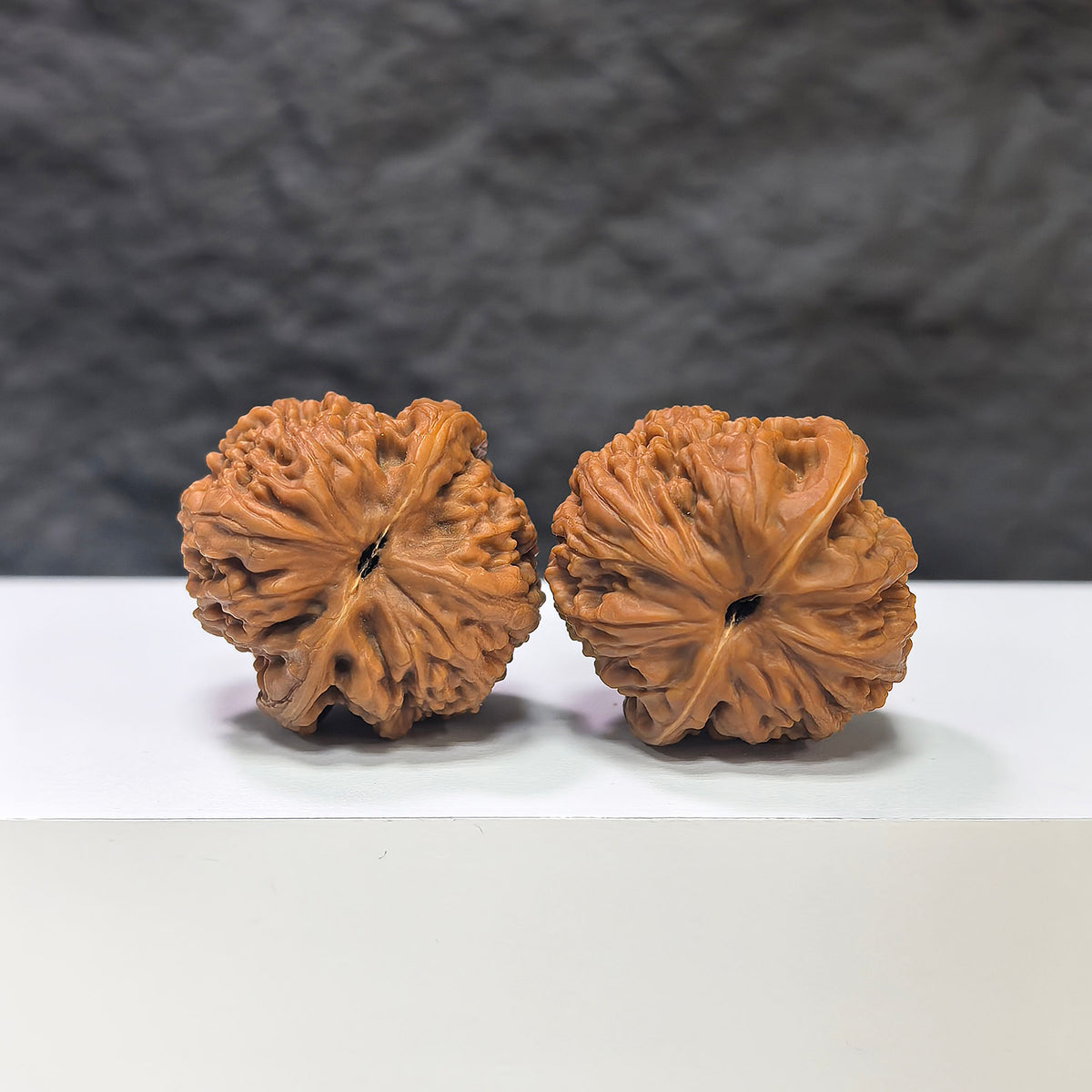 Pair of Nuwa Stone Wenwan walnuts from Wenwan Art, 38mm, showing smooth, polished surface, natural stone patterns, and walnut shape.