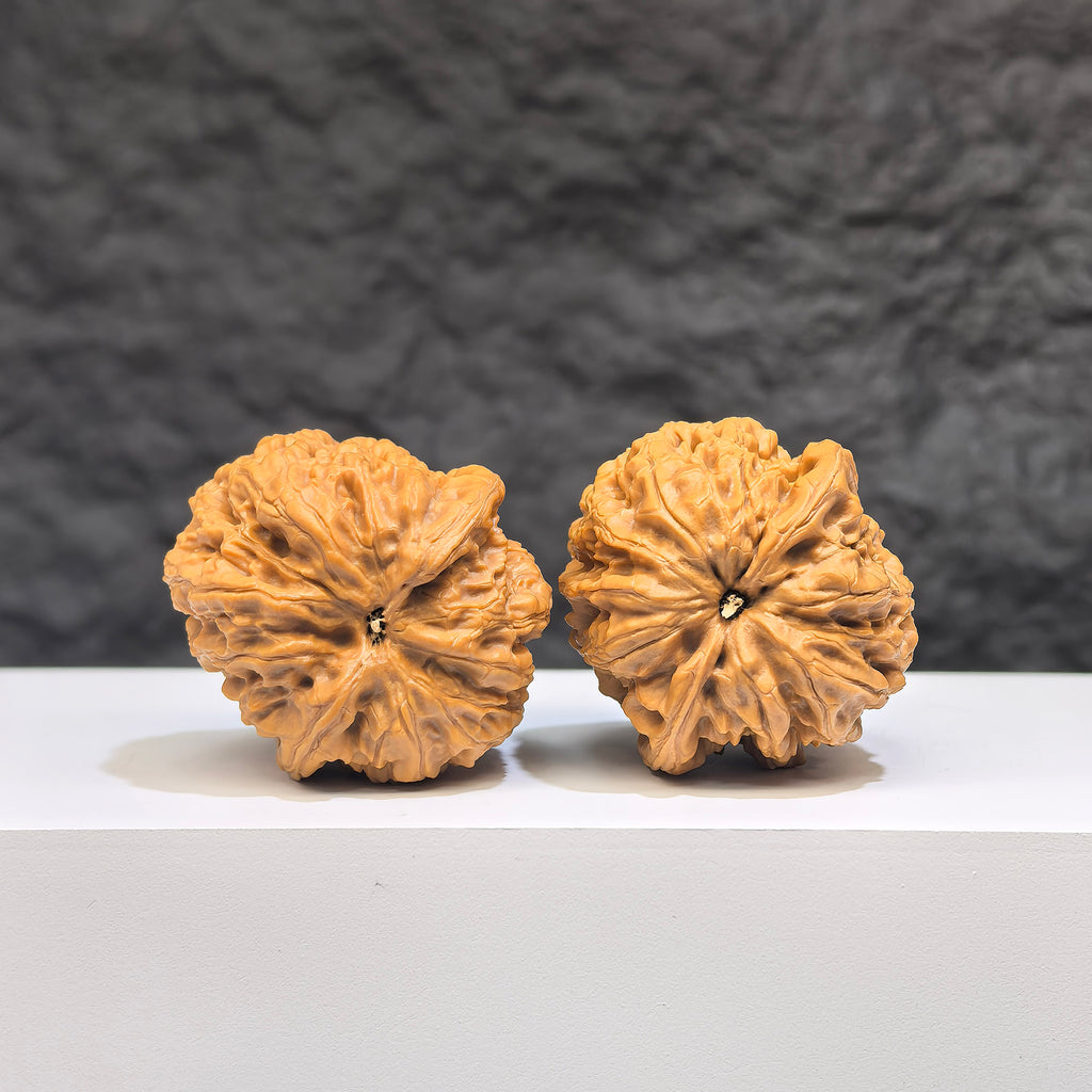 Miniature Wenwan Walnut pair by Wenwan Art, 32mm pocket-sized Yuhua stones, detailed natural stone carvings with textured surface.