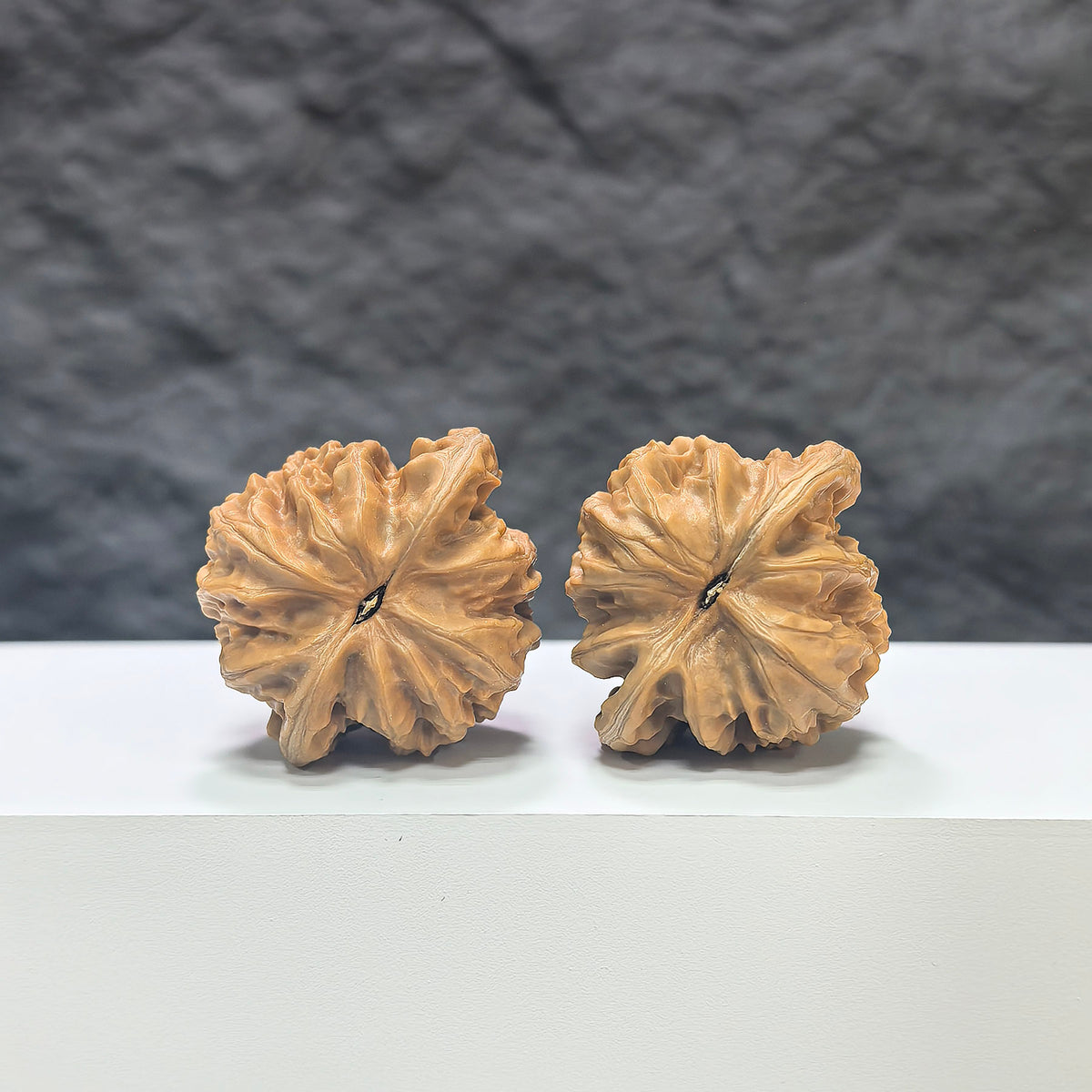 Pair of Peach Heart Xiayunling Wenwan walnuts from Wenwan Art, showcasing smooth textured walnut shells with peach heart shapes.