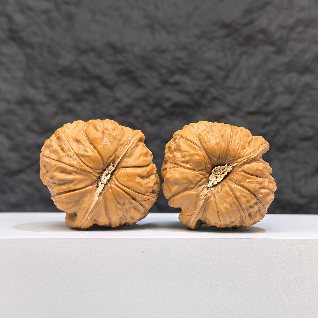 Pair of Wenwan Art Hundred Beasts Lion Head Wenwan walnuts featuring carved lion head designs, measuring 43mm by 40mm.