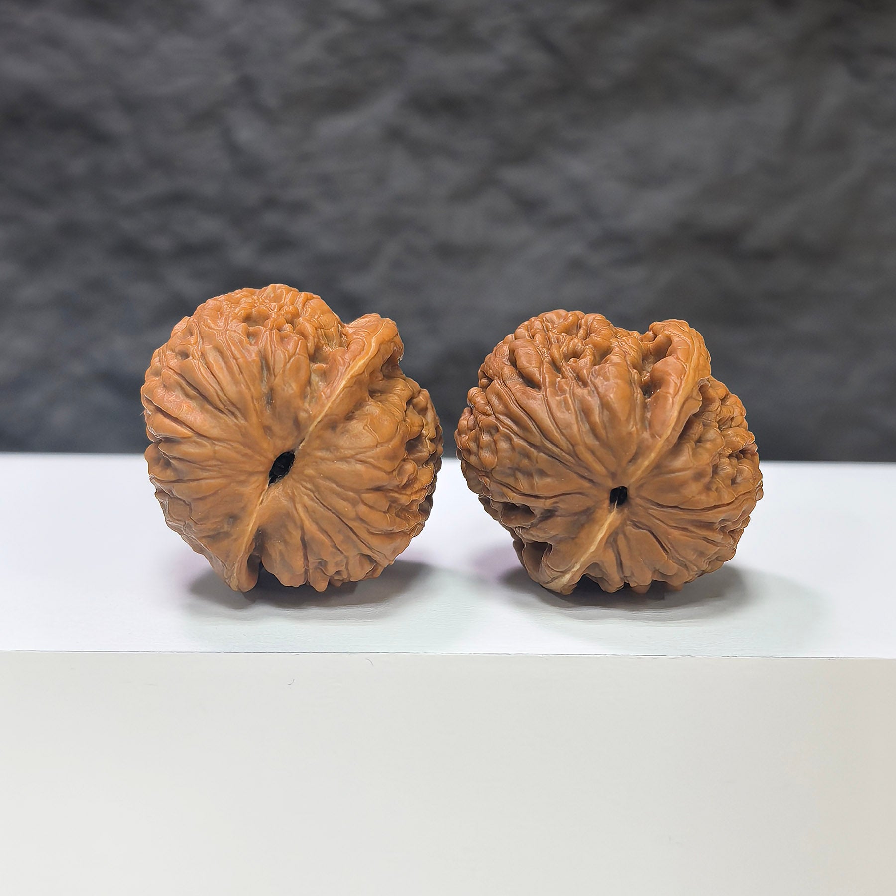 Miniature Wenwan Walnut pair featuring pocket meteorite sycees, crafted by Wenwan Art, measuring 30x31mm with detailed natural textures.