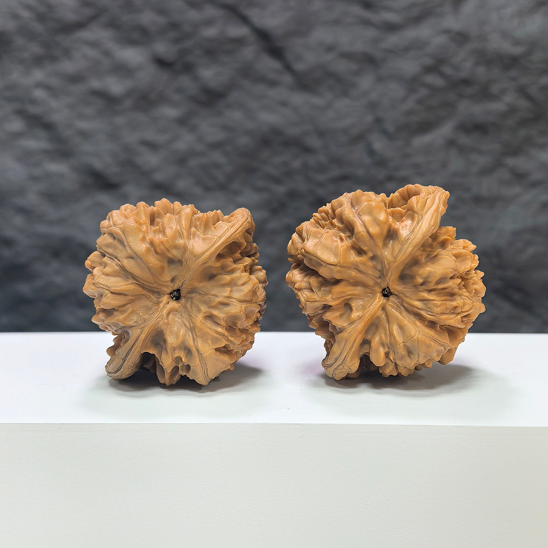 Wenwan Art official hat-shaped Wenwan walnut pair, 44mm x 40mm, featuring detailed carvings on smooth walnut surfaces.