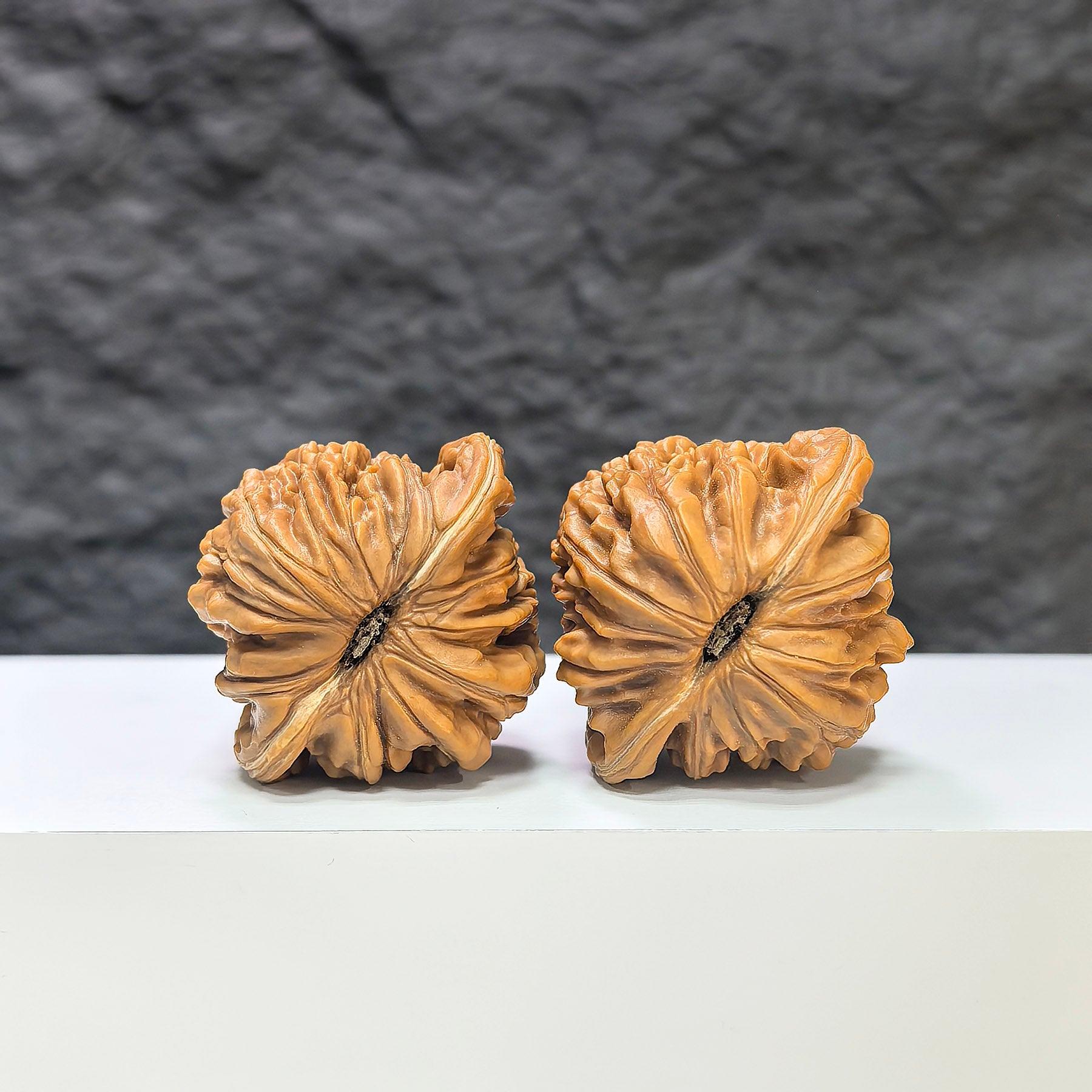 Pair of Sizuolou Wenwan walnuts by Wenwan Art, classic 41mm x 37mm natural walnut carvings, detailed wood texture visible.