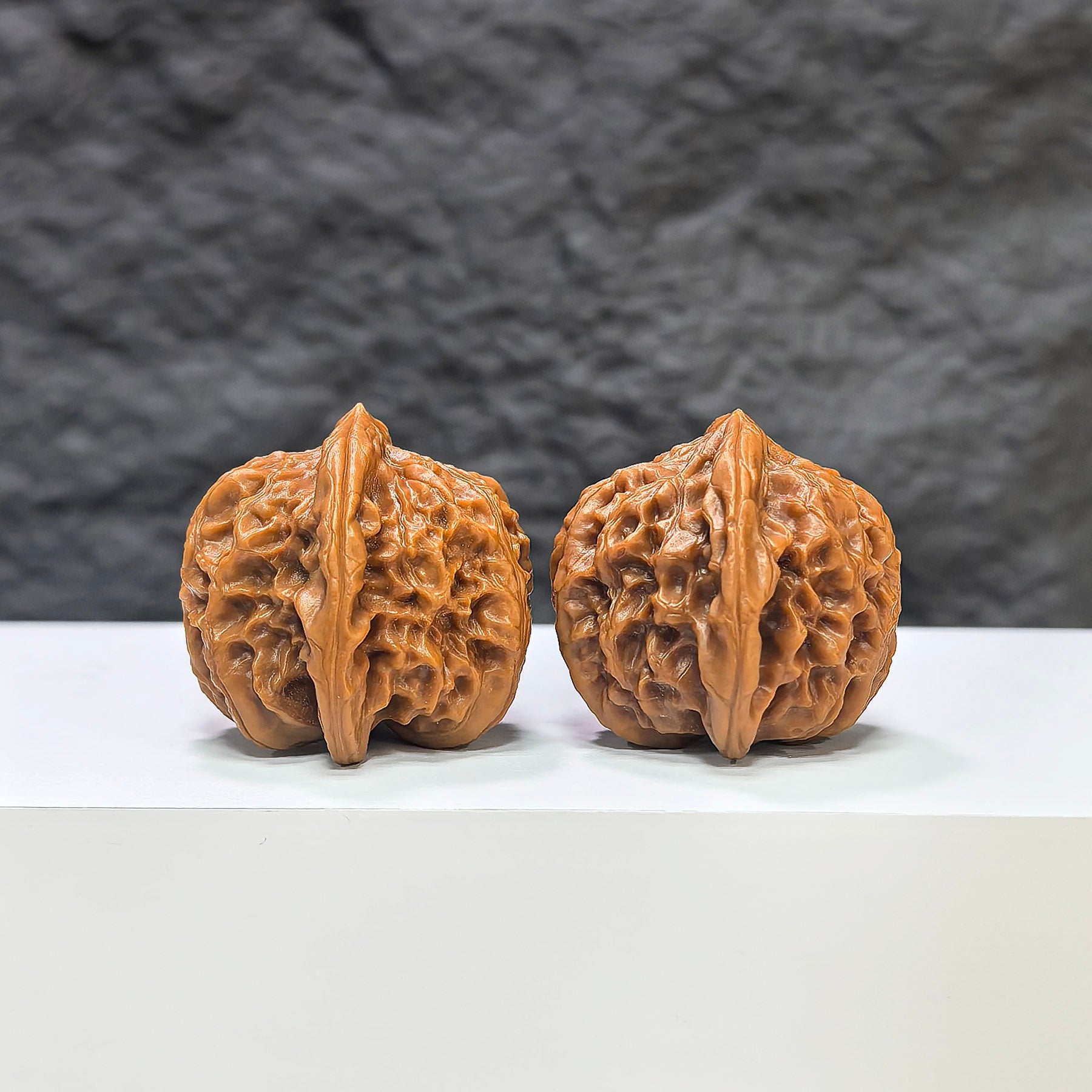 Pair of Pocket Sizuolou Wenwan walnuts by Wenwan Art, miniature 33mm walnut sculptures with intricate carved details.