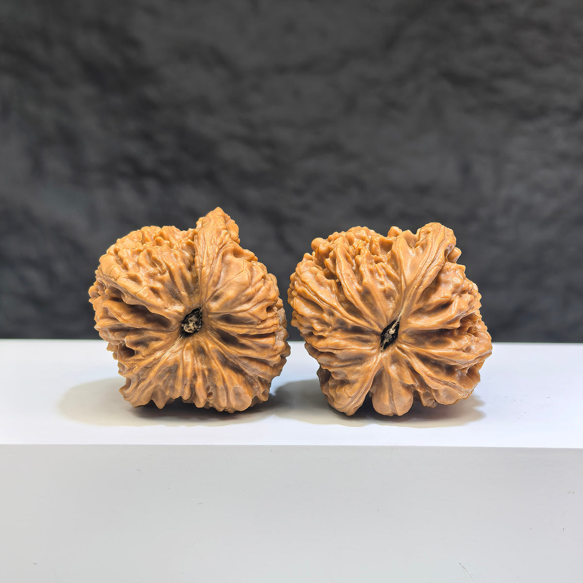 Pair of Nanjiangstone Wenwan walnuts from Wenwan Art, 36mm diameter, showcasing smooth, polished stone with natural patterns.
