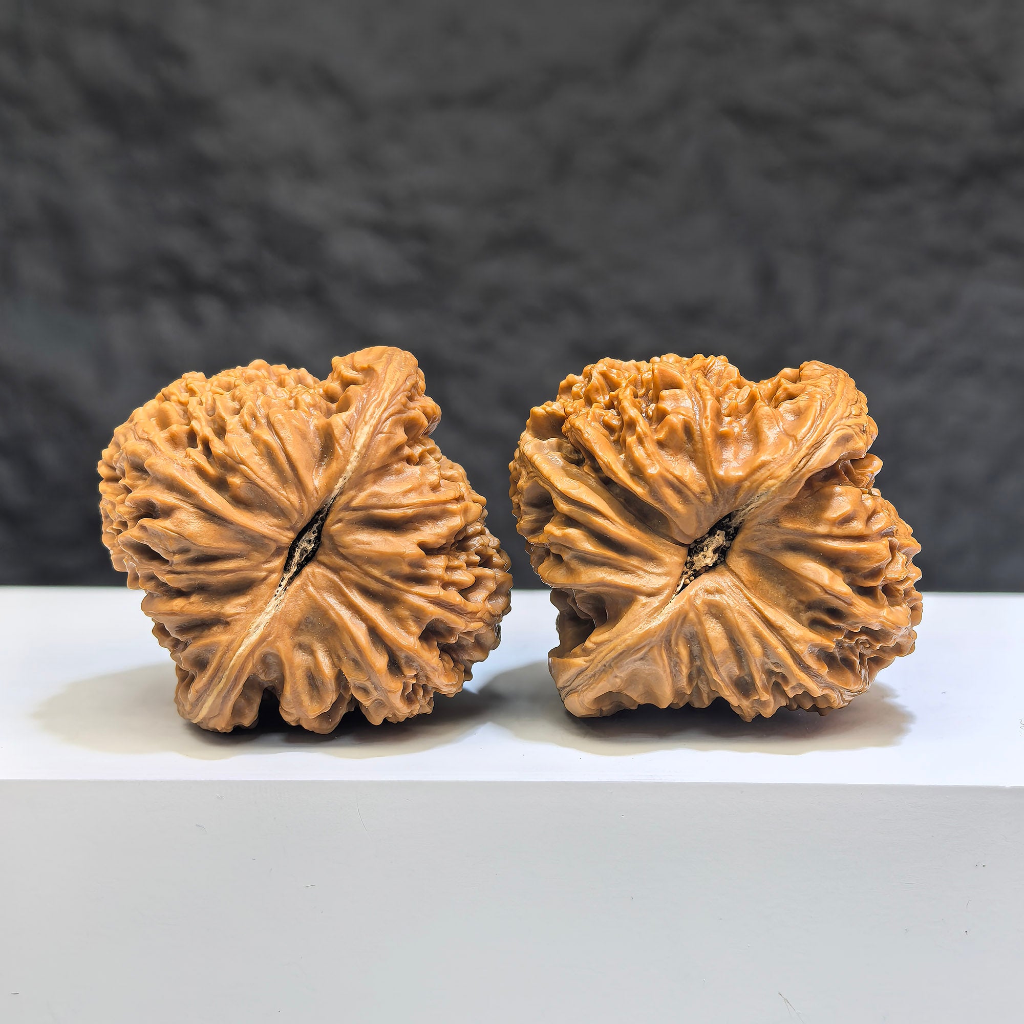 Pair of Wenwan Art Tri-Angular Concave Base Nanjiangstone Wenwan walnuts, deep-base, 40mm, showcasing intricate stone craftsmanship.