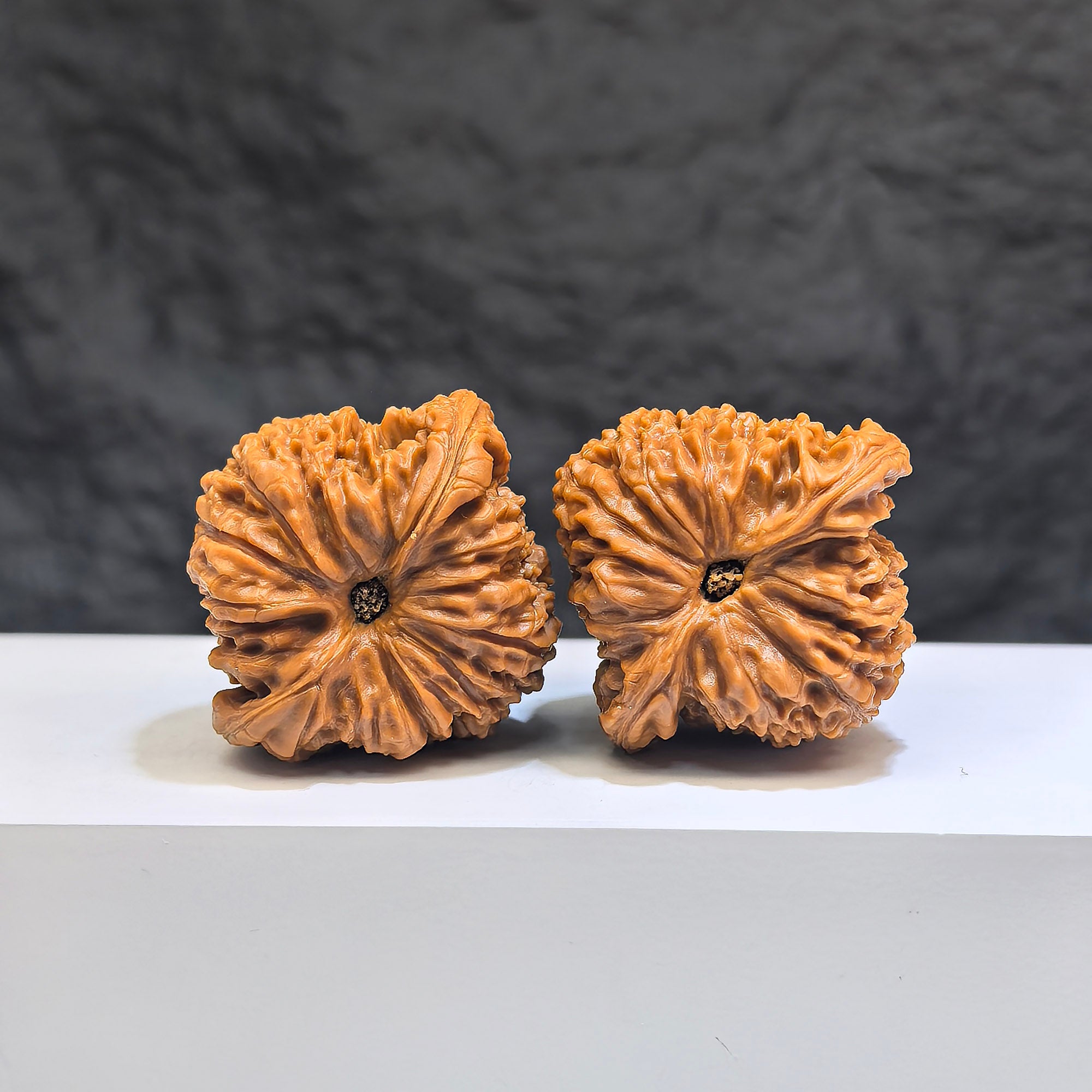 Pair of red shell Nanjiangstone Wenwan walnuts from Wenwan Art, 40mm x 38mm, showcasing vibrant red shells and polished surfaces.