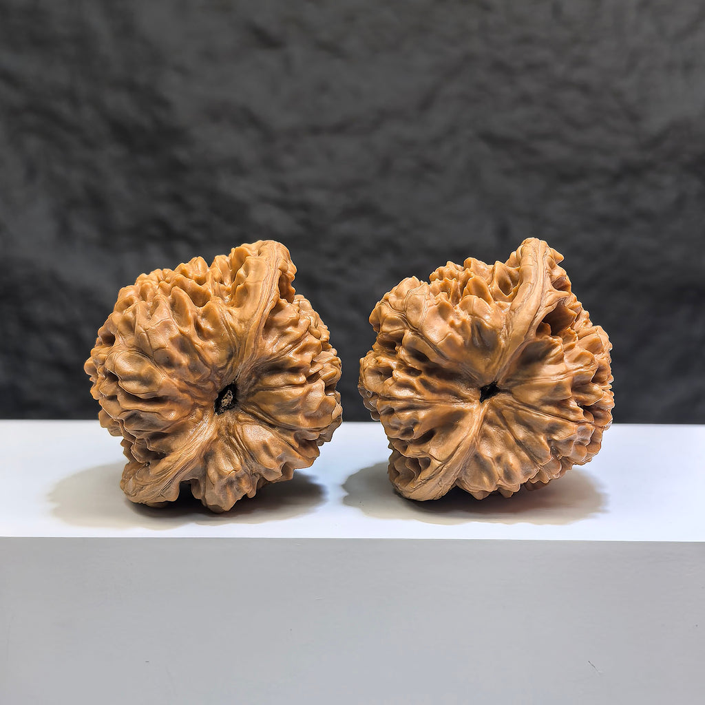 Pair of Classic Scholar Wenwan Walnuts by Wenwan Art, featuring peach heart carved design, 47mm and 43mm size.