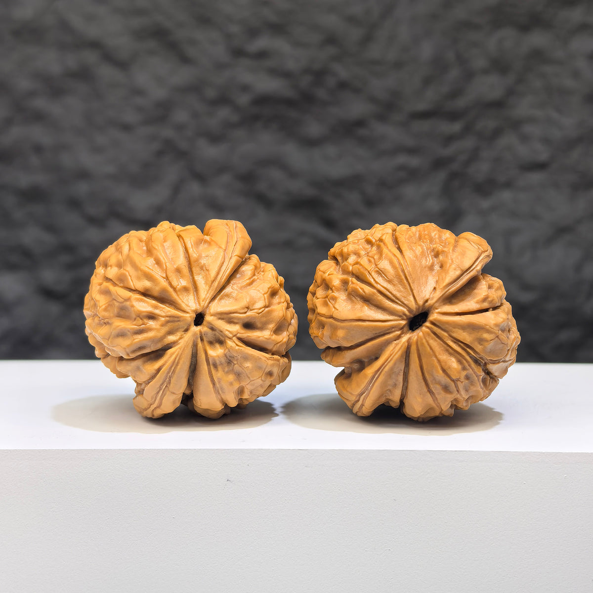 Miniature Wenwan walnut pair with Oracle Bone Script carvings, measuring 33mm x 31mm, by Wenwan Art.