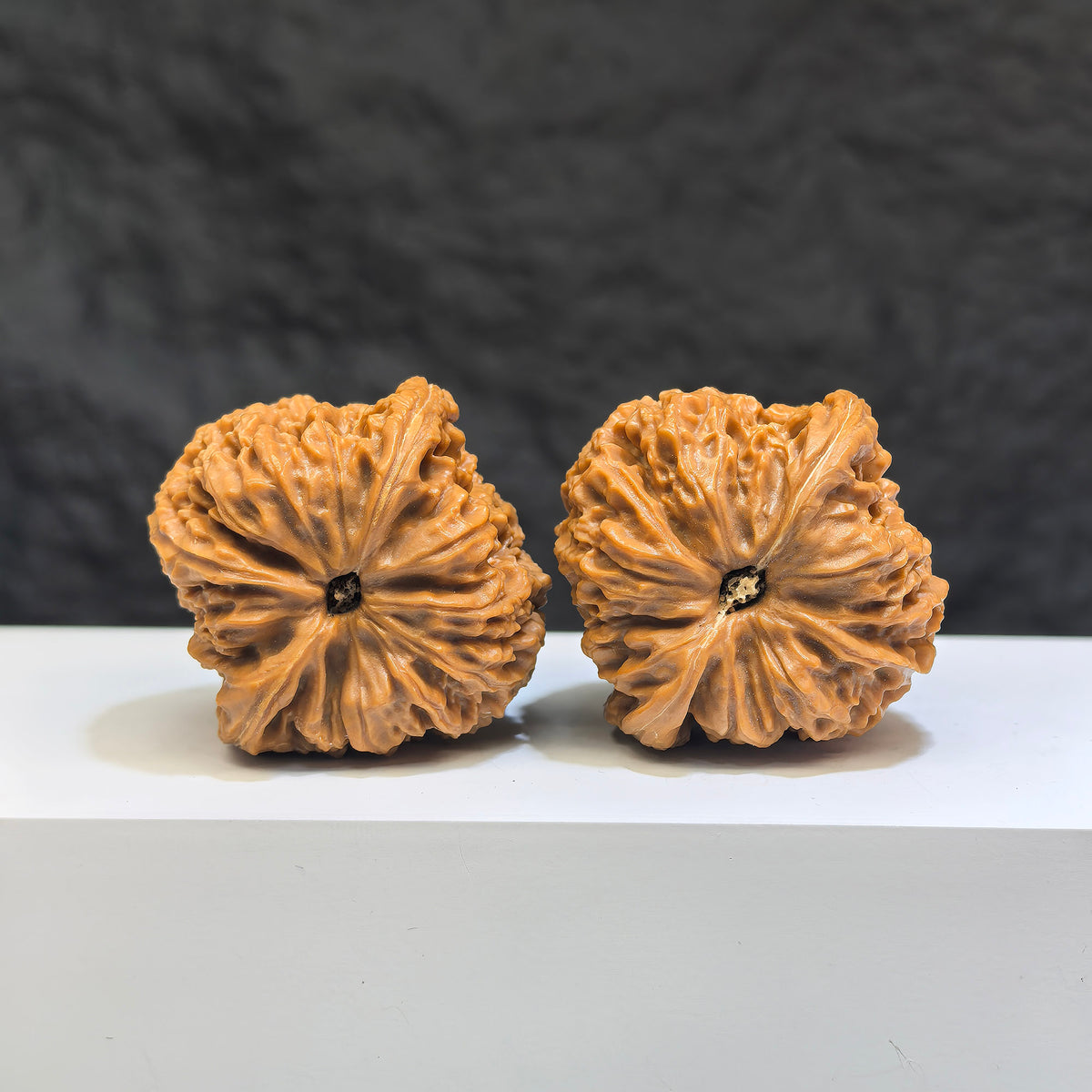 Pair of Nanjiangstone Wenwan walnuts by Wenwan Art, 38mm x 39mm, showcasing natural stone textures and craftsmanship.