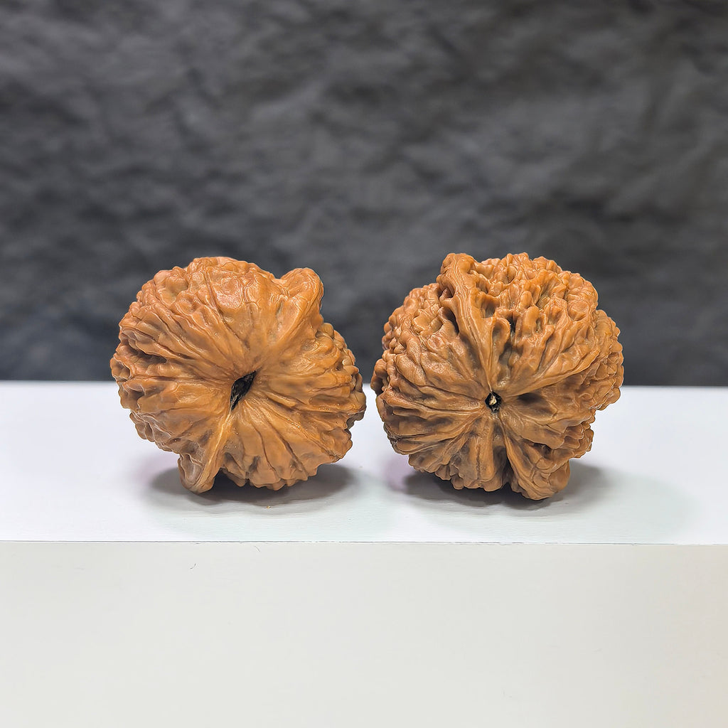 Miniature Wenwan Walnut pair with meteorite inset, crafted by Wenwan Art, measuring 31mm, showcasing unique natural stone details.