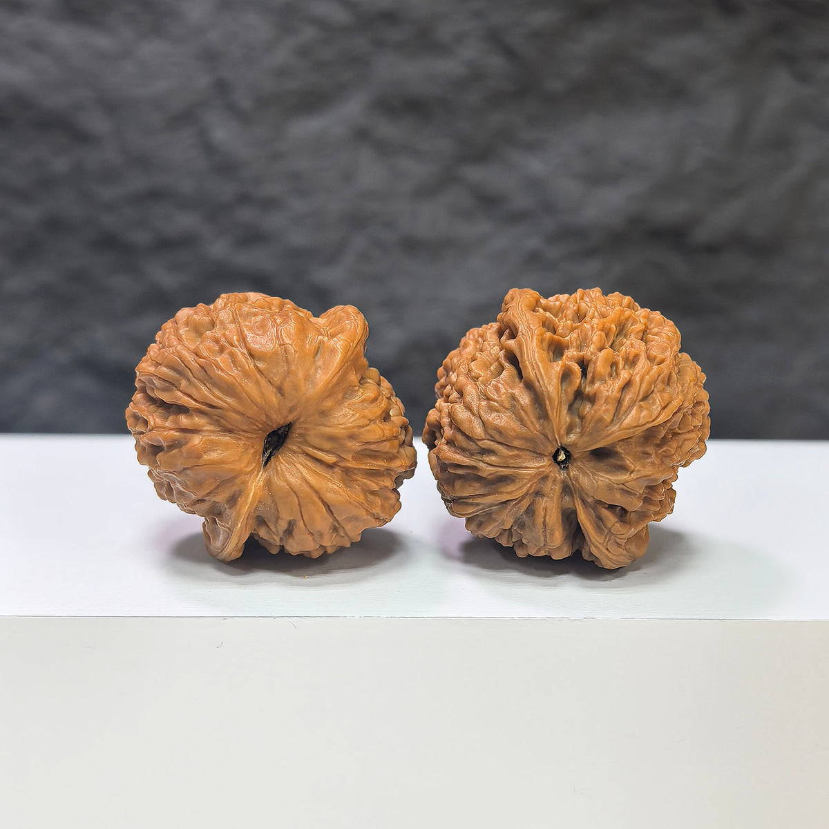 Miniature Wenwan Walnut pair with meteorite inset, crafted by Wenwan Art, measuring 31mm, showcasing unique natural stone details.