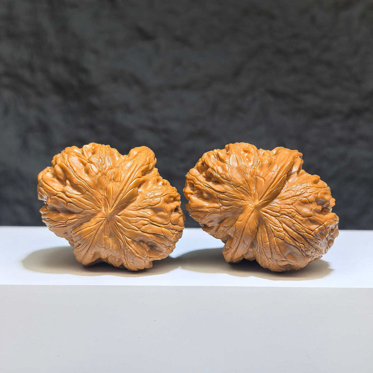 Pair of Pinggu Sycee Yuanbao-shaped Wenwan walnuts from Wenwan Art, 39mm x 46mm, featuring intricate carved details.