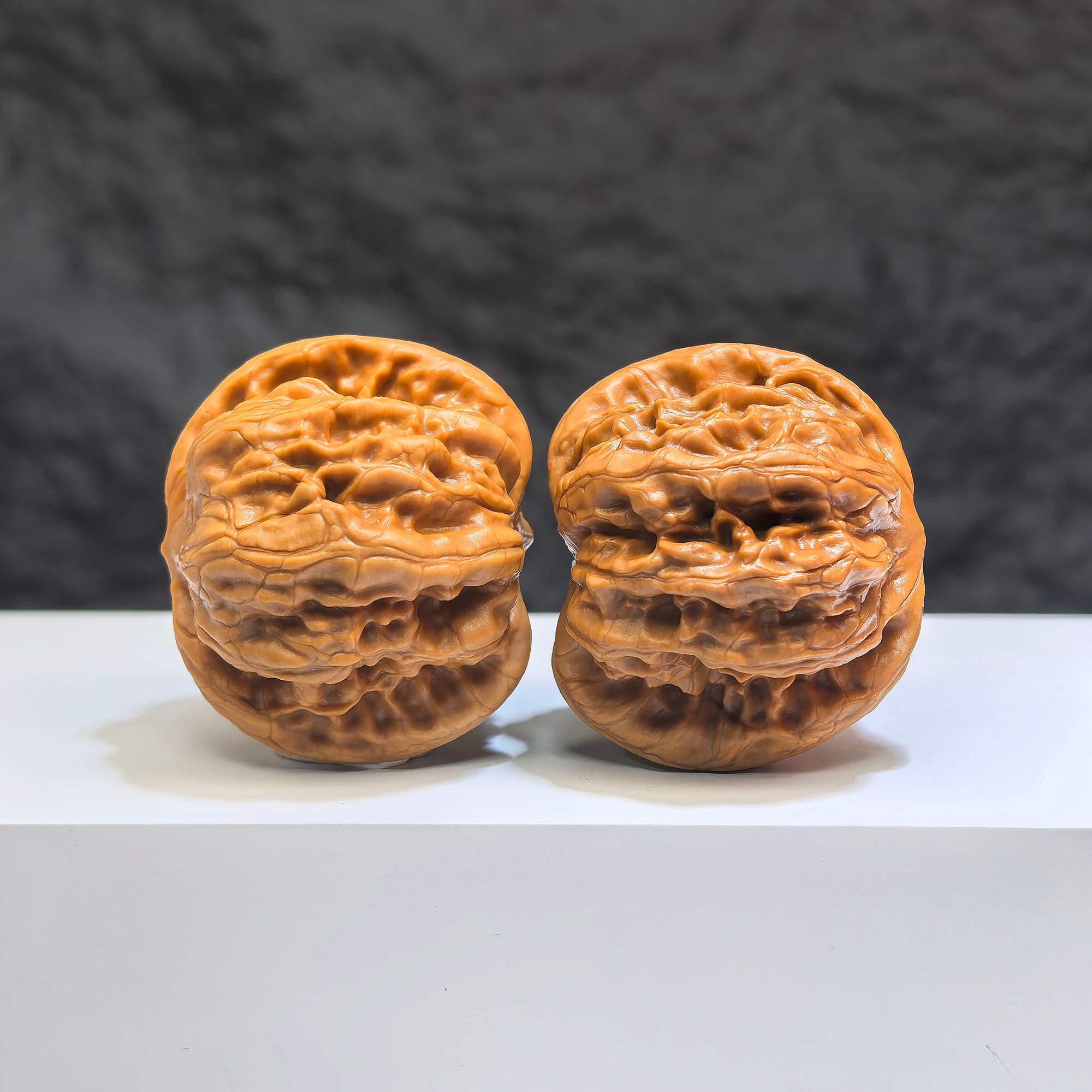 Pair of Wild Wolf Yelang Deep-Carved Wenwan walnuts from Wenwan Art, 38mm x 36mm, showcasing intricate carvings on walnut surfaces.