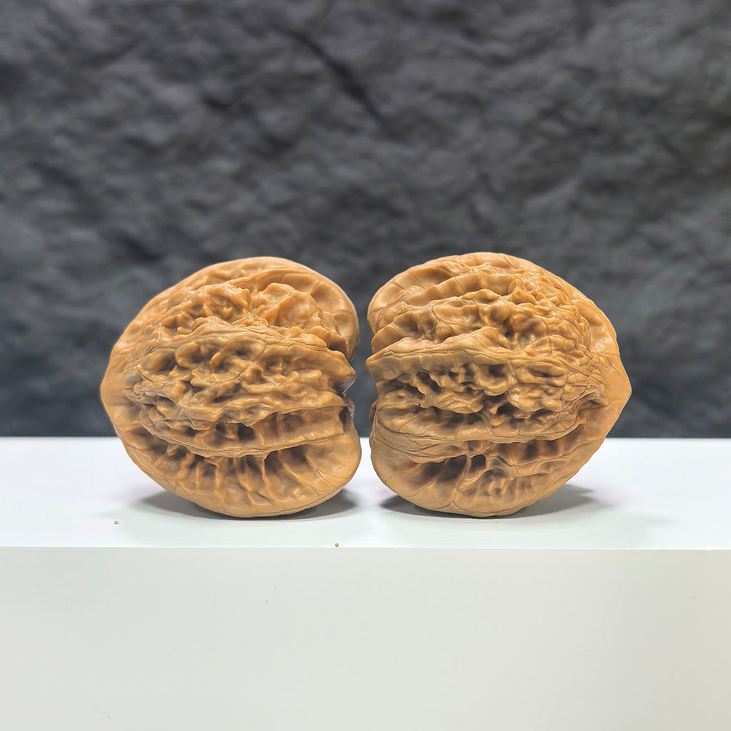 Pair of Peach Heart Concave Base Xiayunling Wenwan Walnuts from Wenwan Art, deep-base with smooth, rounded peach-shaped surface.