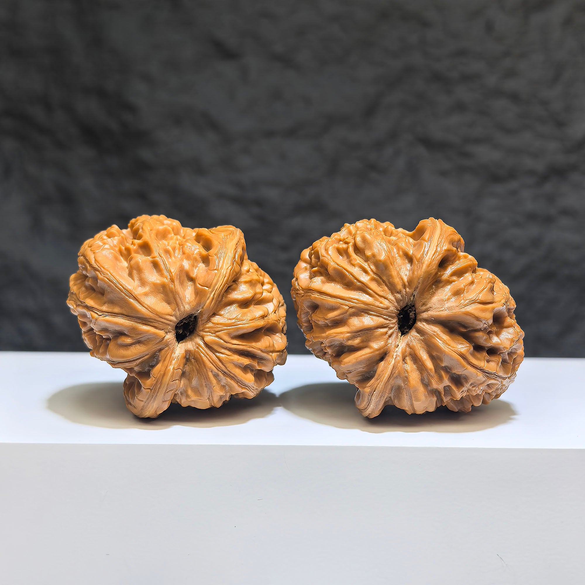 Pair of Pinggu Sycee Yuanbao shaped Wenwan walnuts from Wenwan Art, 39x46mm, featuring ingot-shaped carved detail.