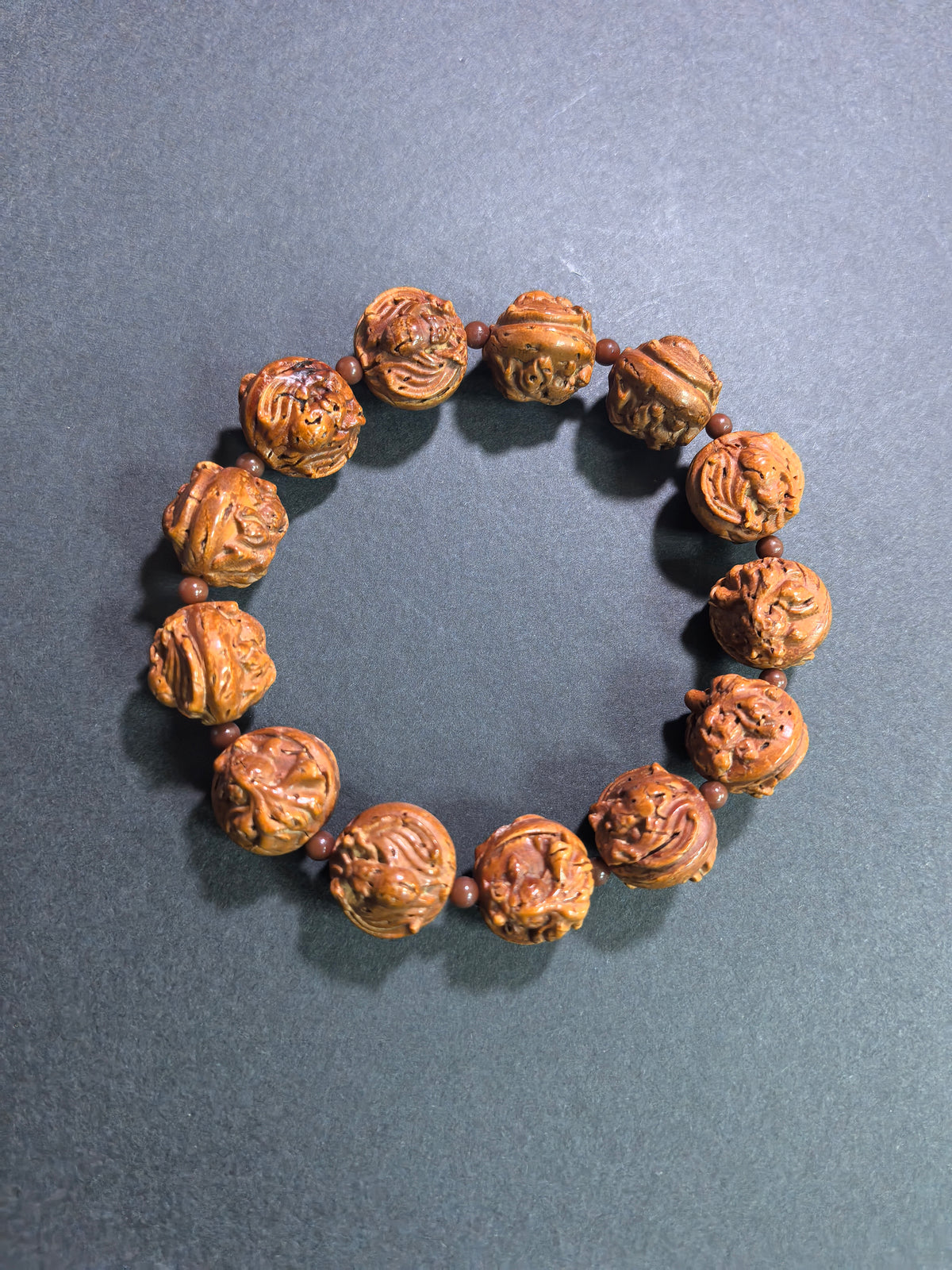 Hand-carved walnut bracelet featuring goldfish and bat motifs, 16mm beads, from ZenWenwan, symbolizing abundance and blessings.